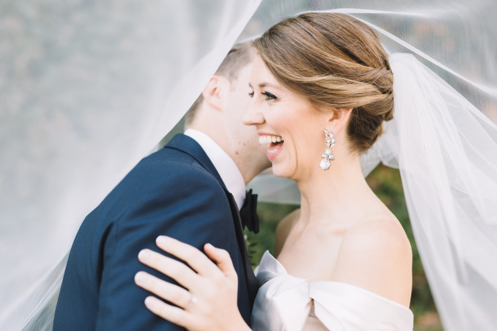 Groom whispering in bride's ear