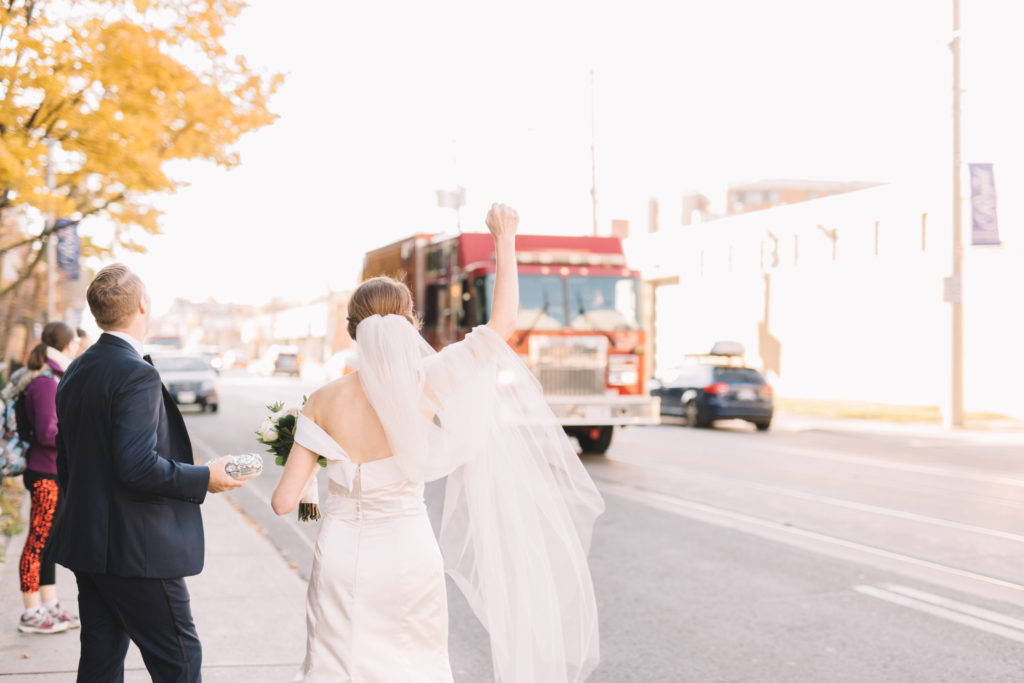 Bride waving at Fire truck passing by