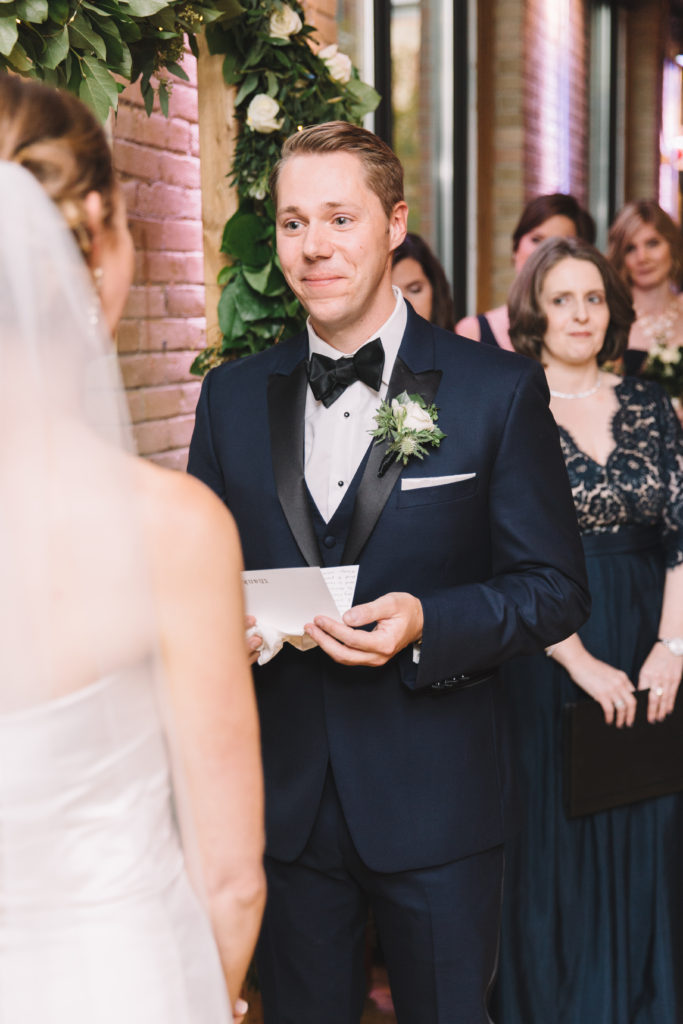 Groom reading vows to bride