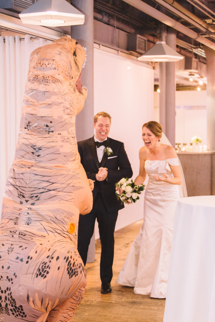 Groom surprises bride with dinosaur costume