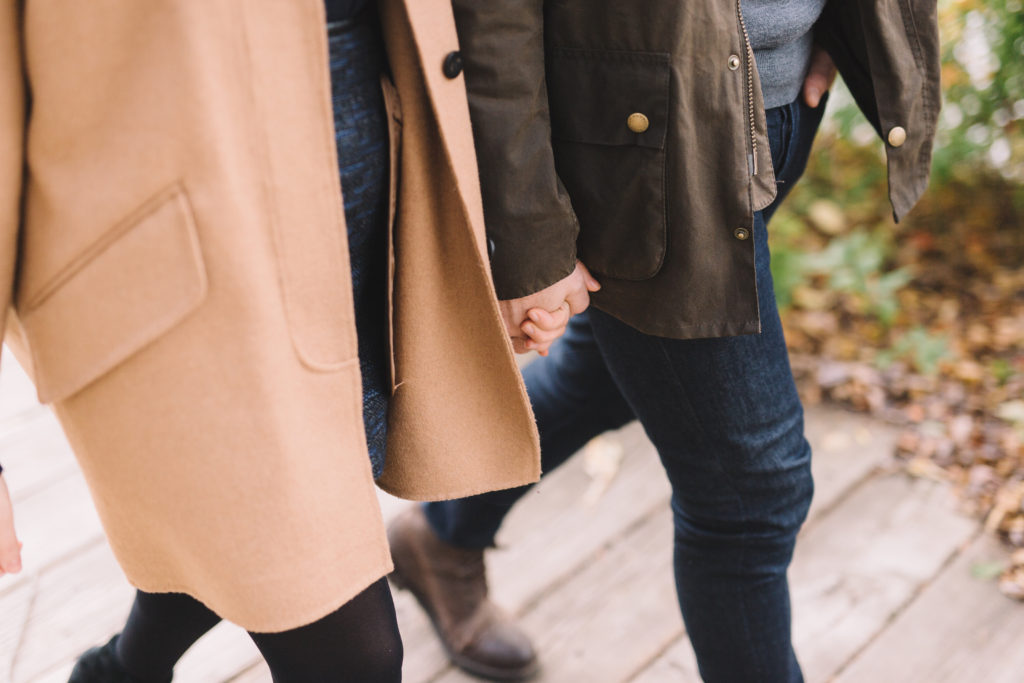 couple holding hands while walking