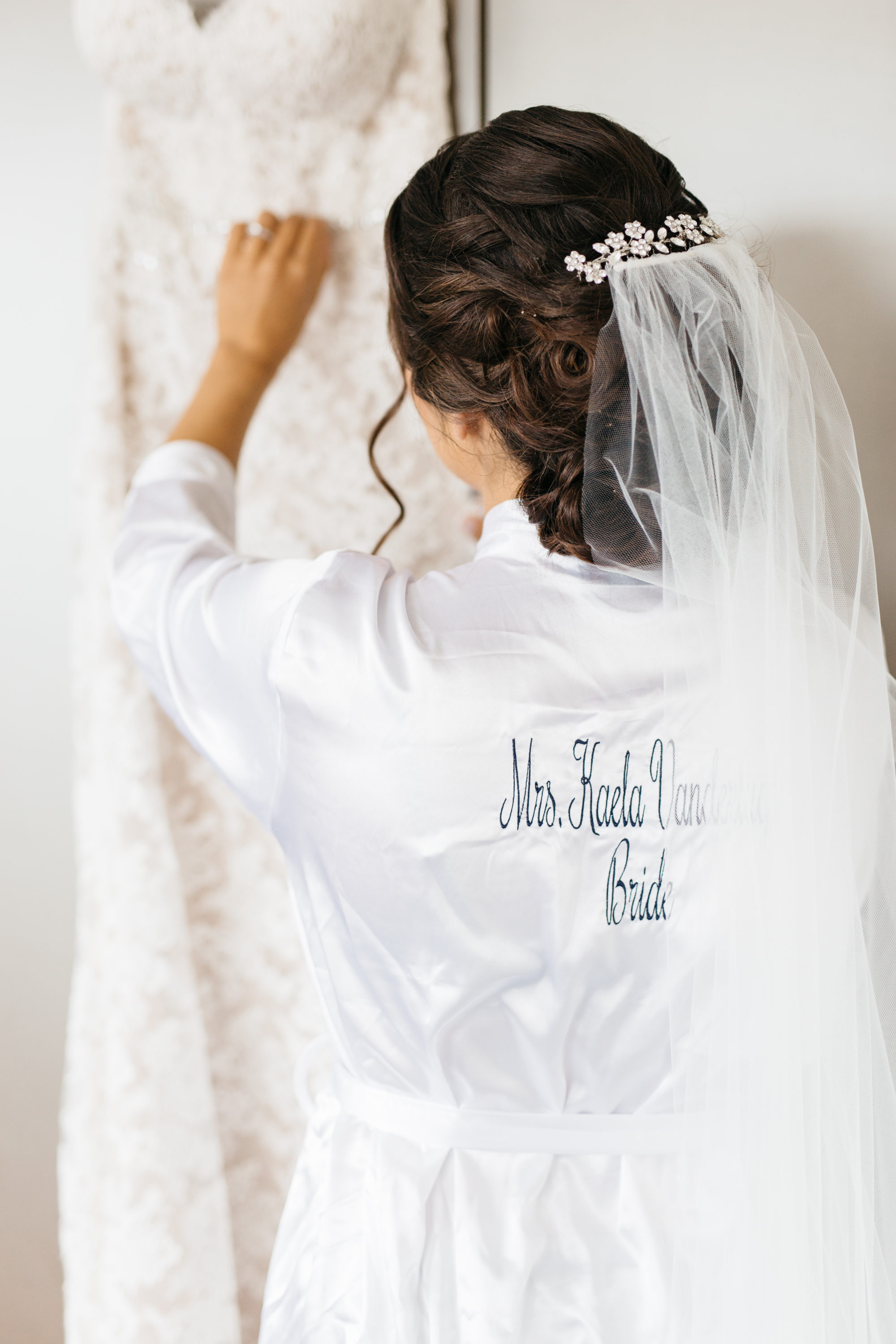 Bride looking at her Reem Arca Wedding gown