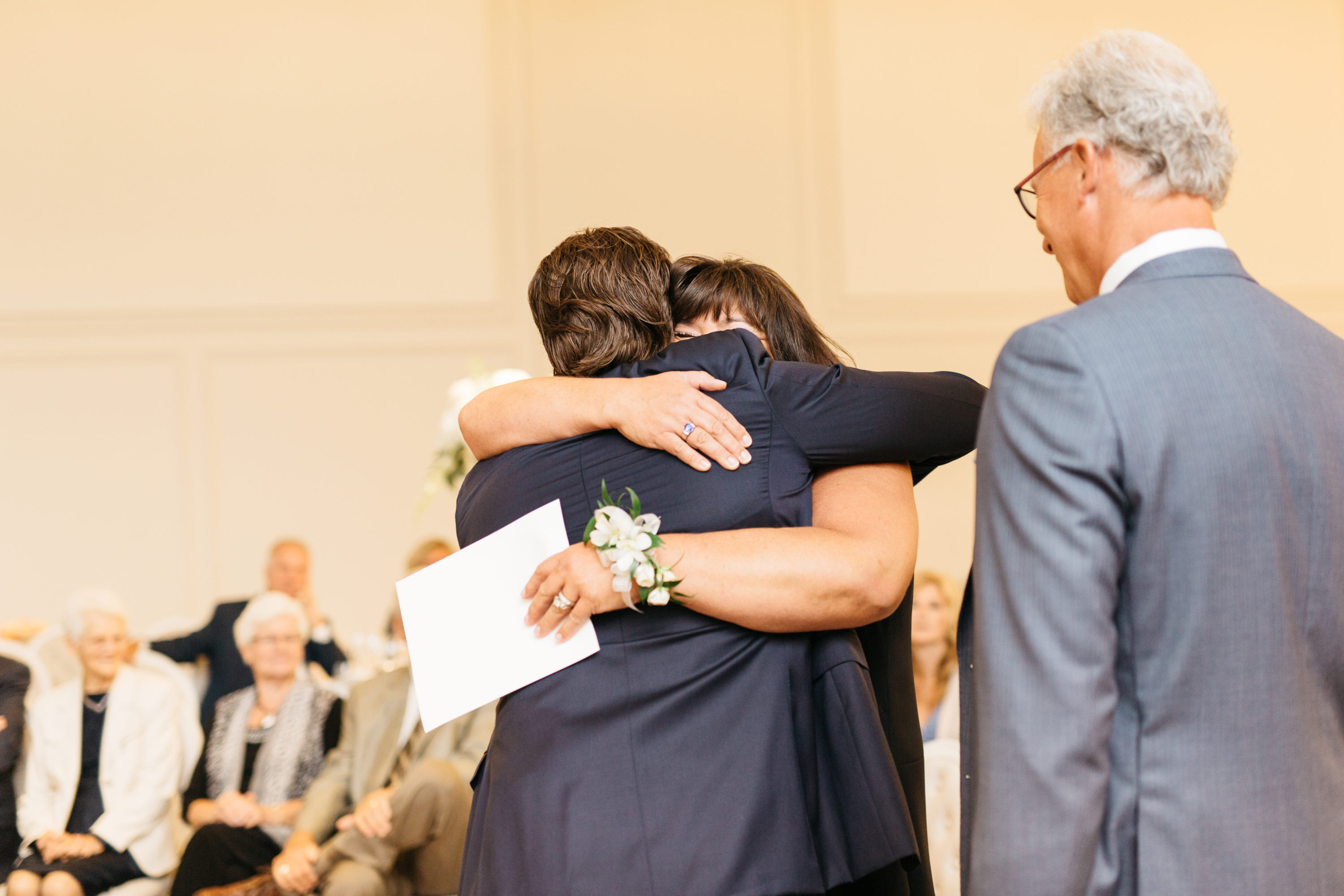 Groom hugging mom during ceremony at the Arlington Estates