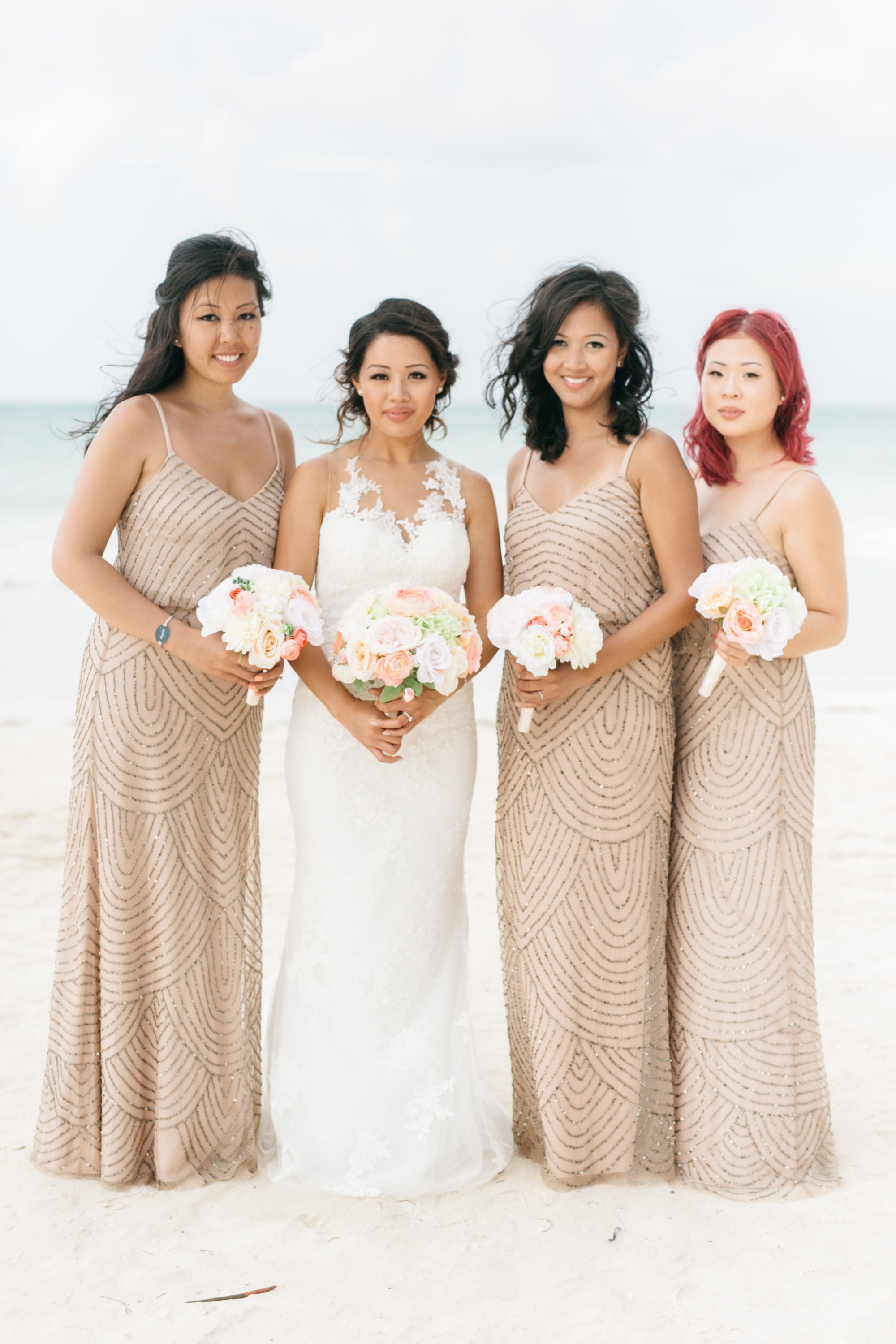 Bride with bridesmaids on beach