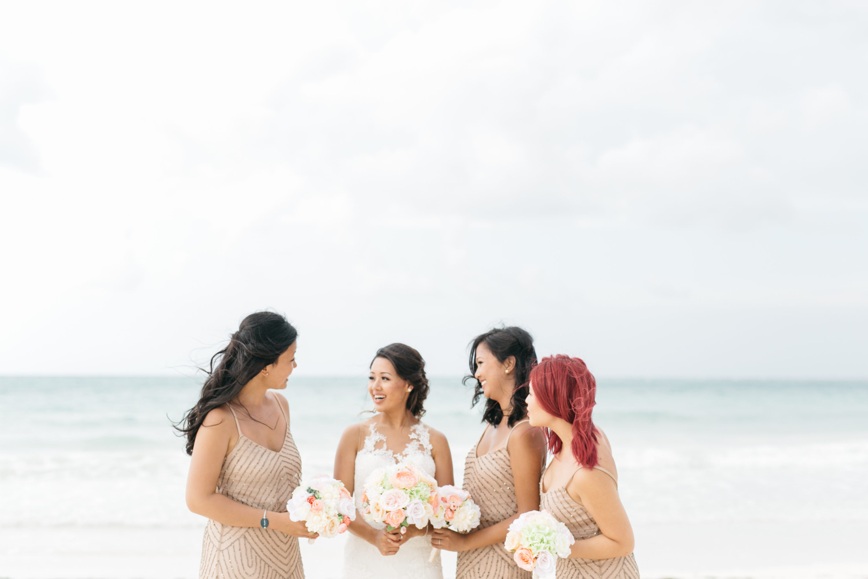 Bride with bridesmaids on beach