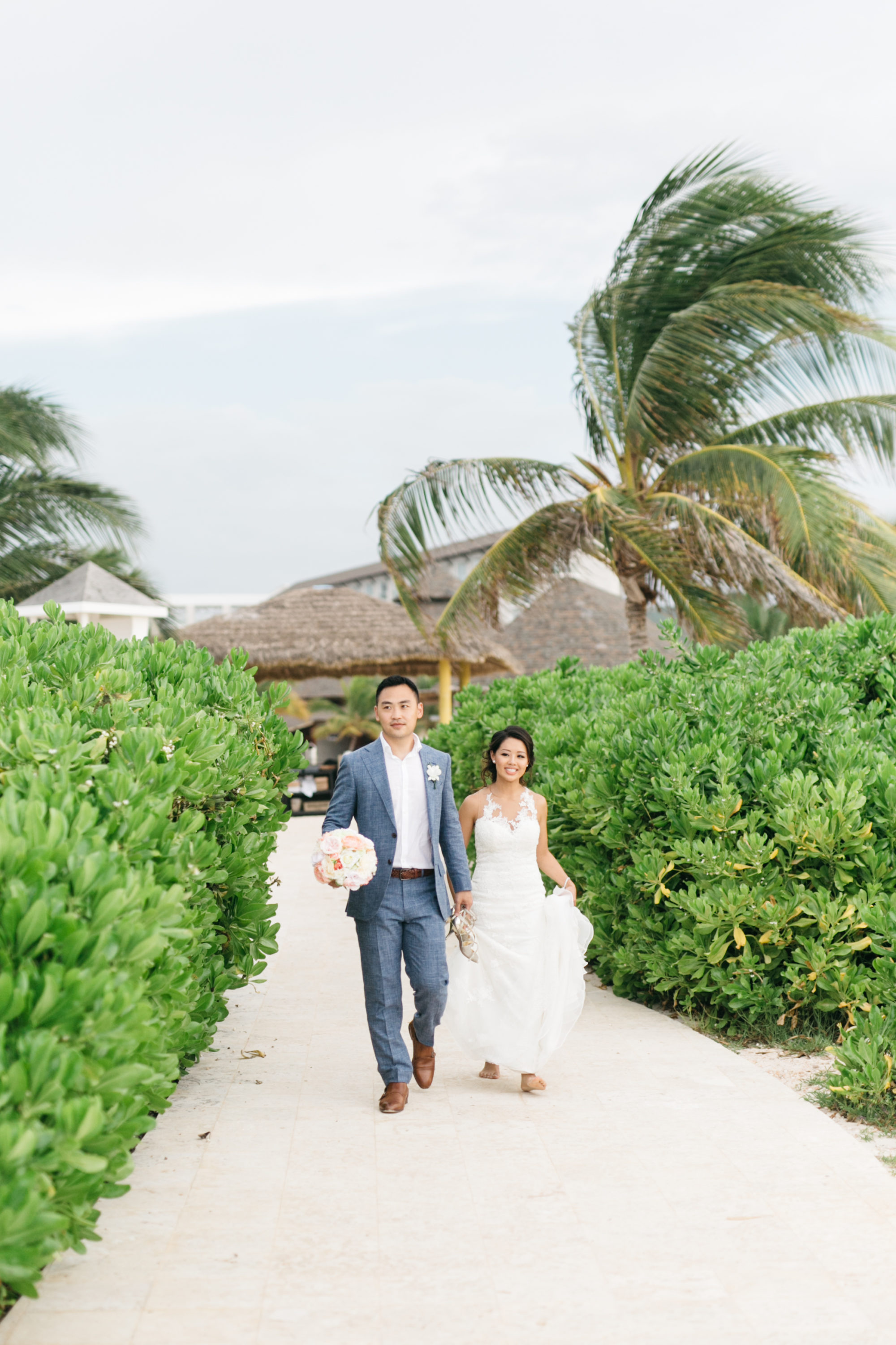 Bride and groom walking on Royalton White Sands Resort
