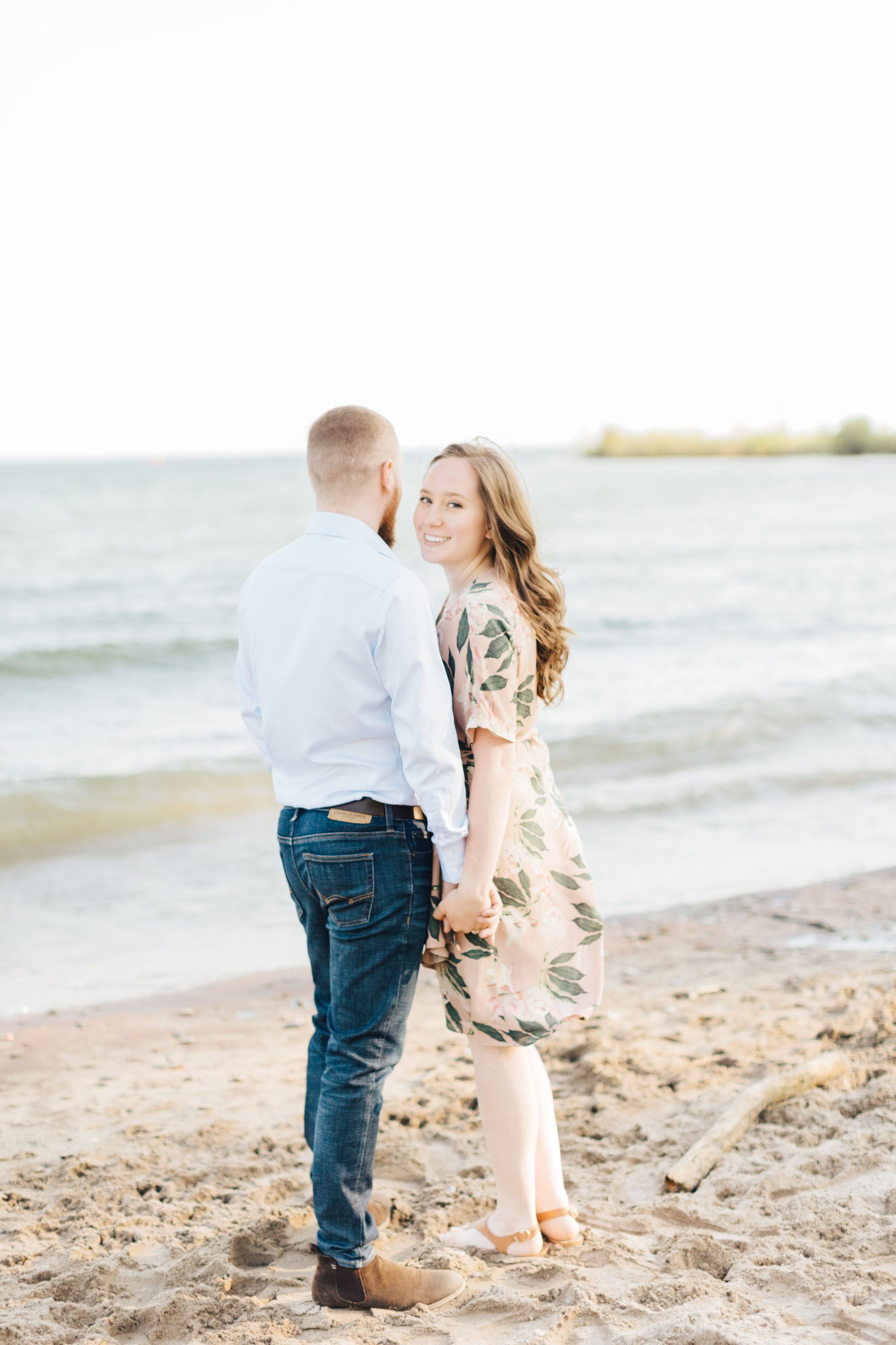 Bride to be smiling at engagement session at cherry beach