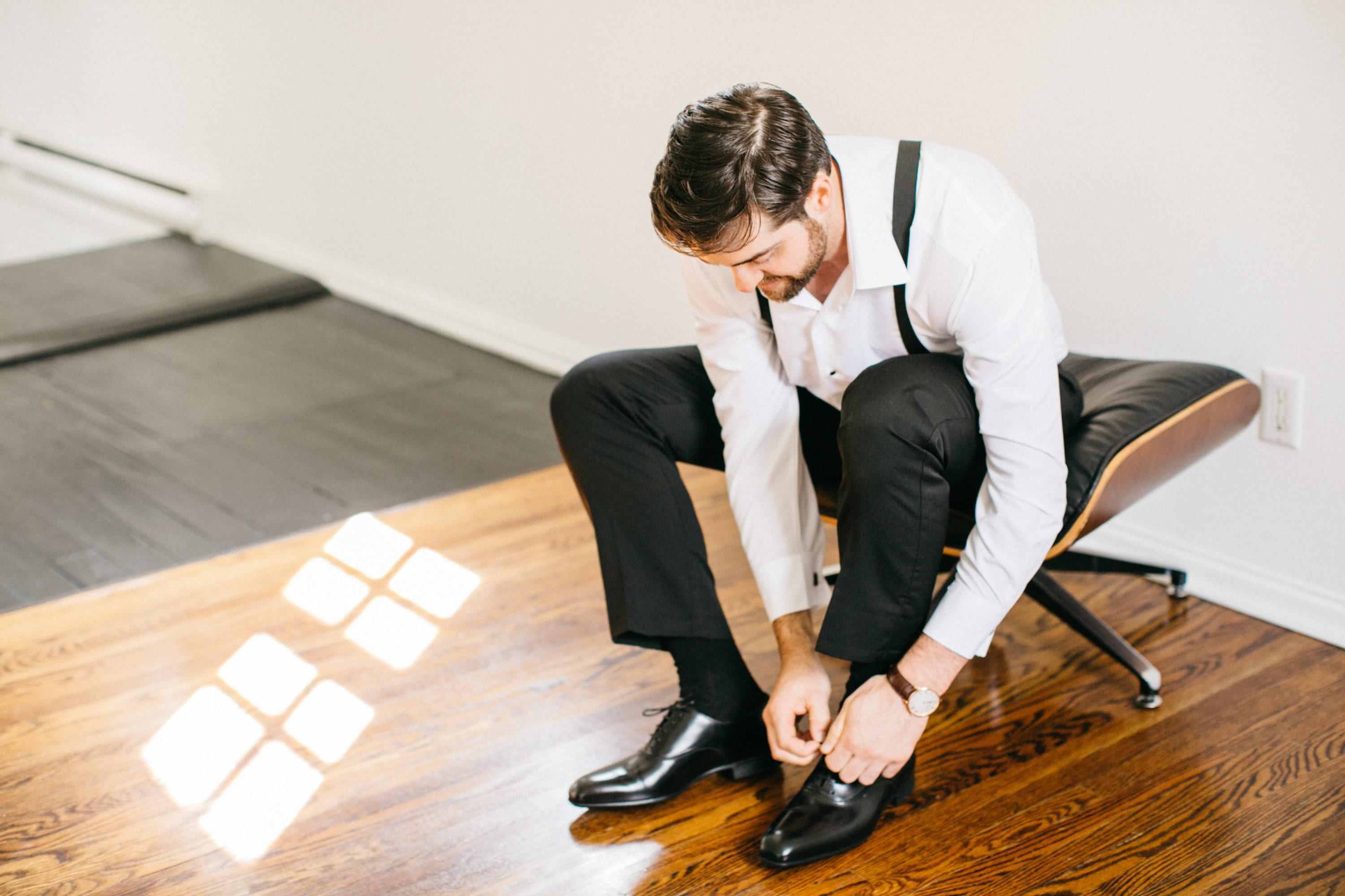 Groom putting shoes on