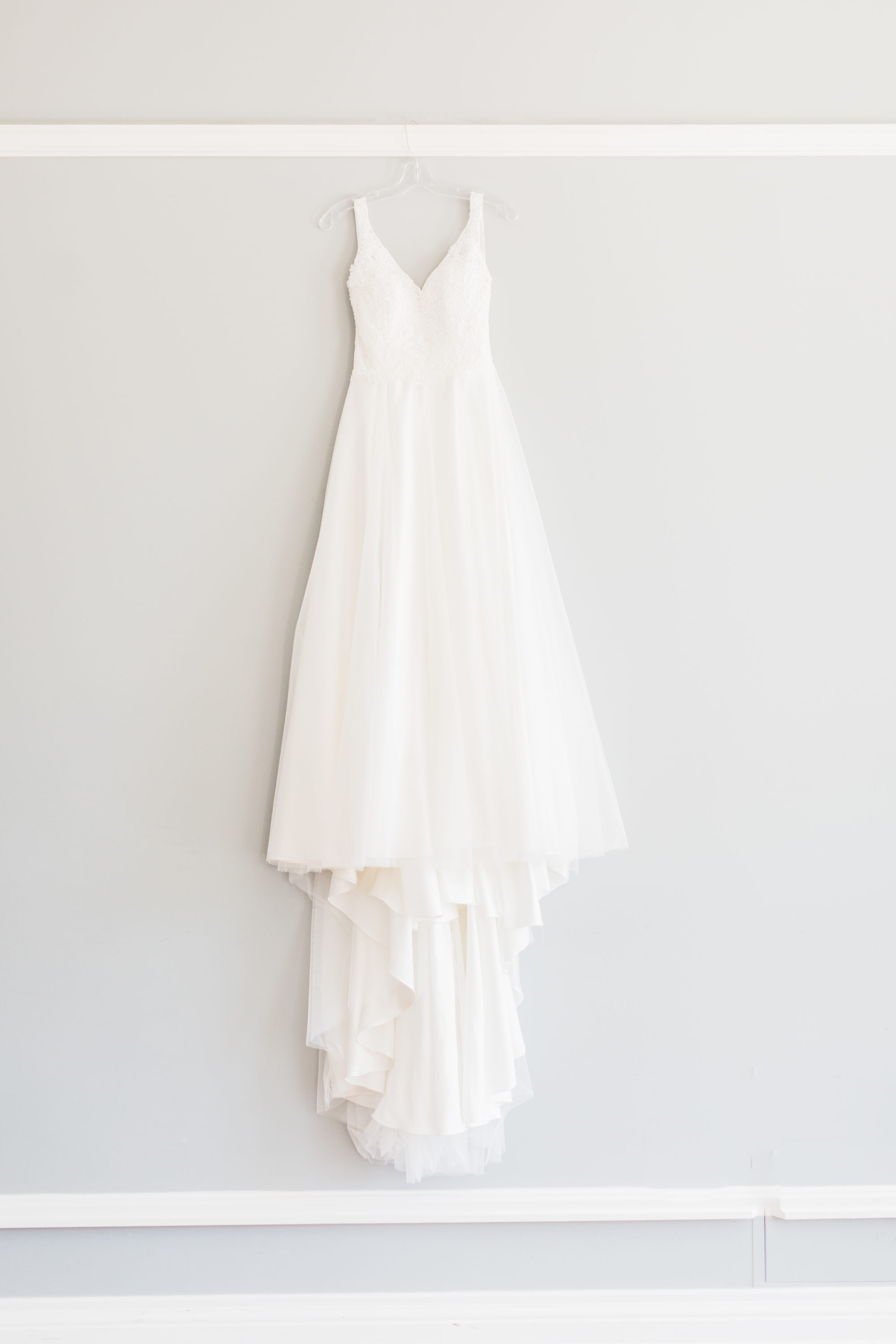 Wedding dress hanging on wall