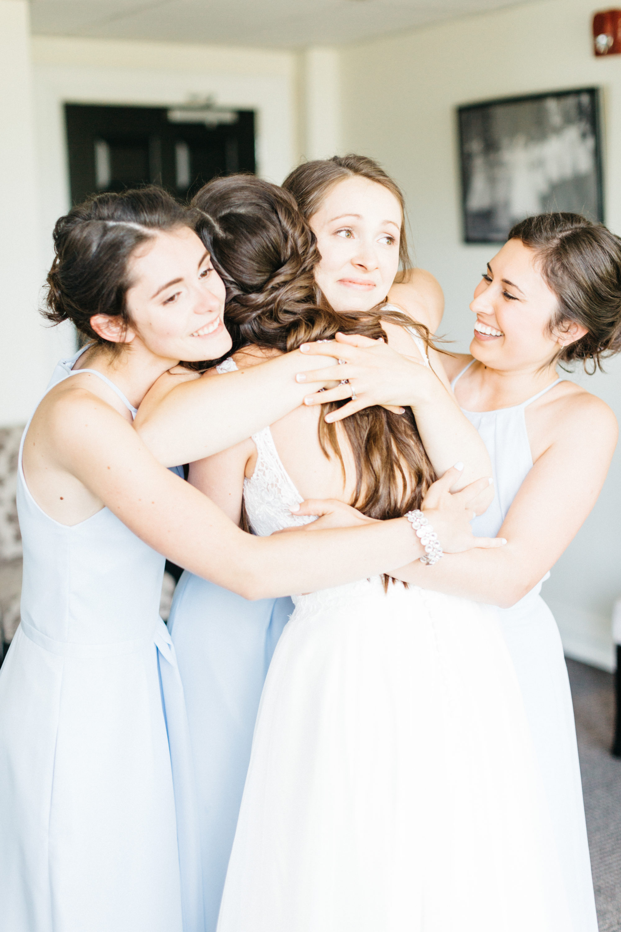 Bride hugging her bridesmaids