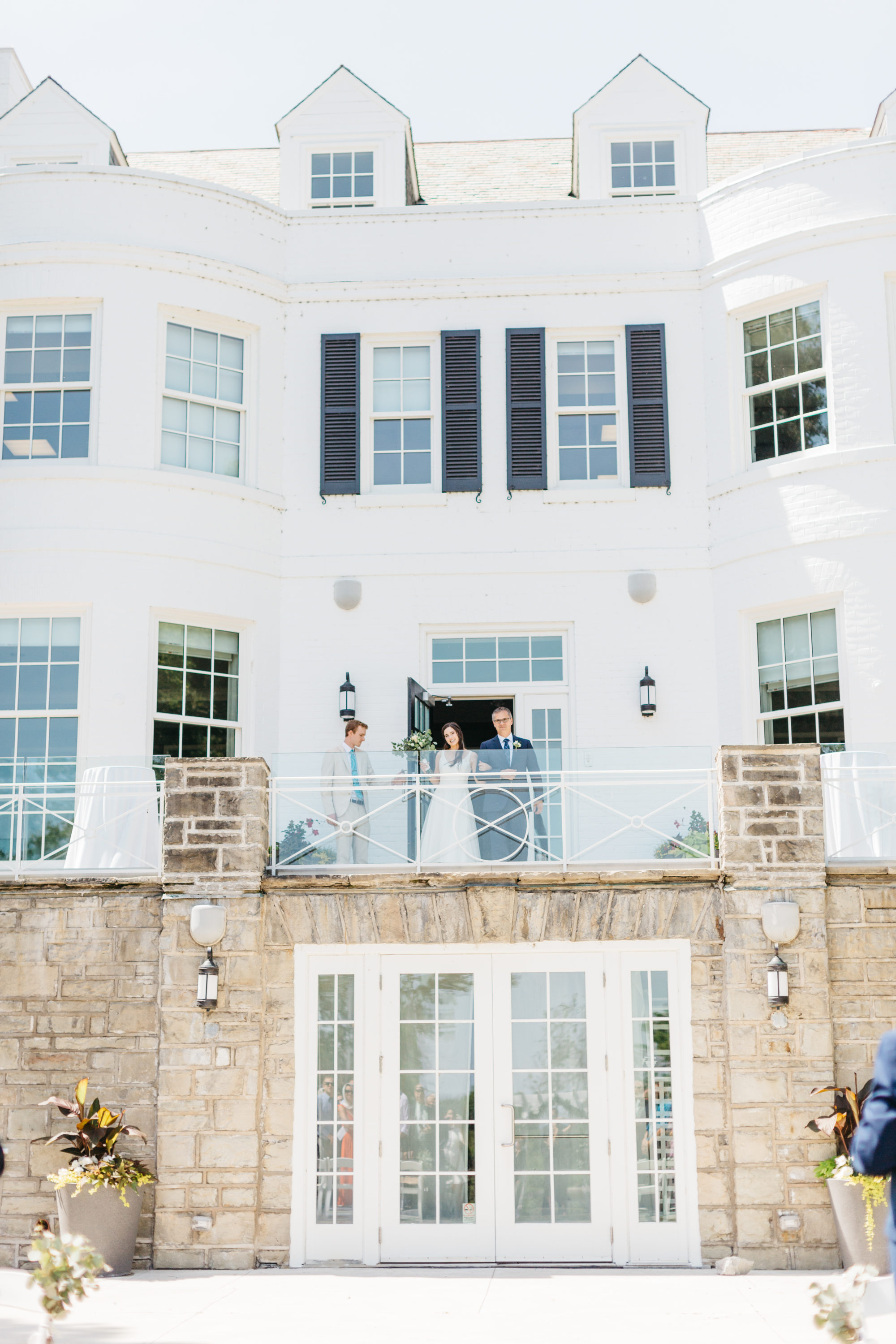 Bride exiting Harding Waterfront Estate balcony at ceremony