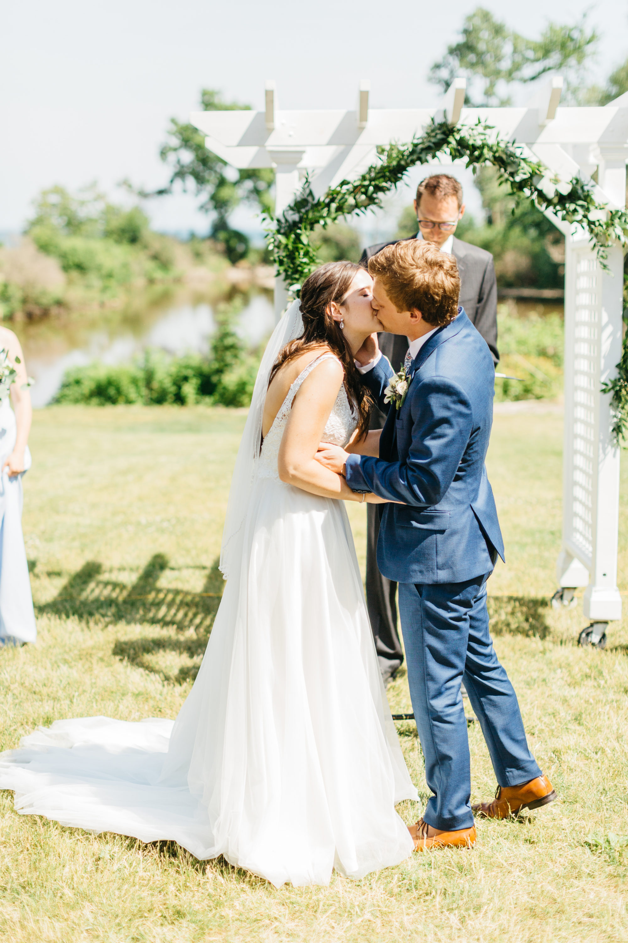 Bride and groom's first kiss at Harding Waterfront Estate
