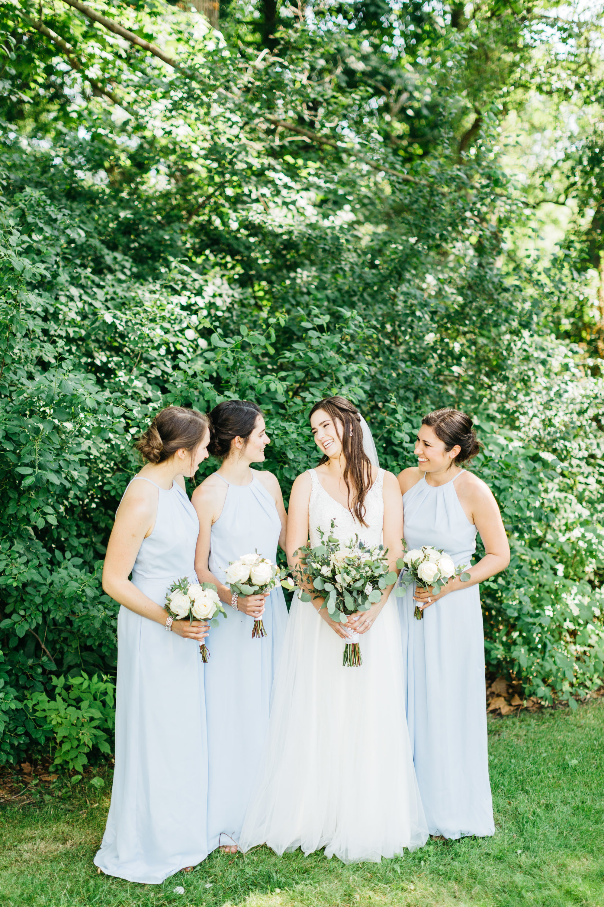 Bride laughing with bridesmaids at Harding Waterfront Estate