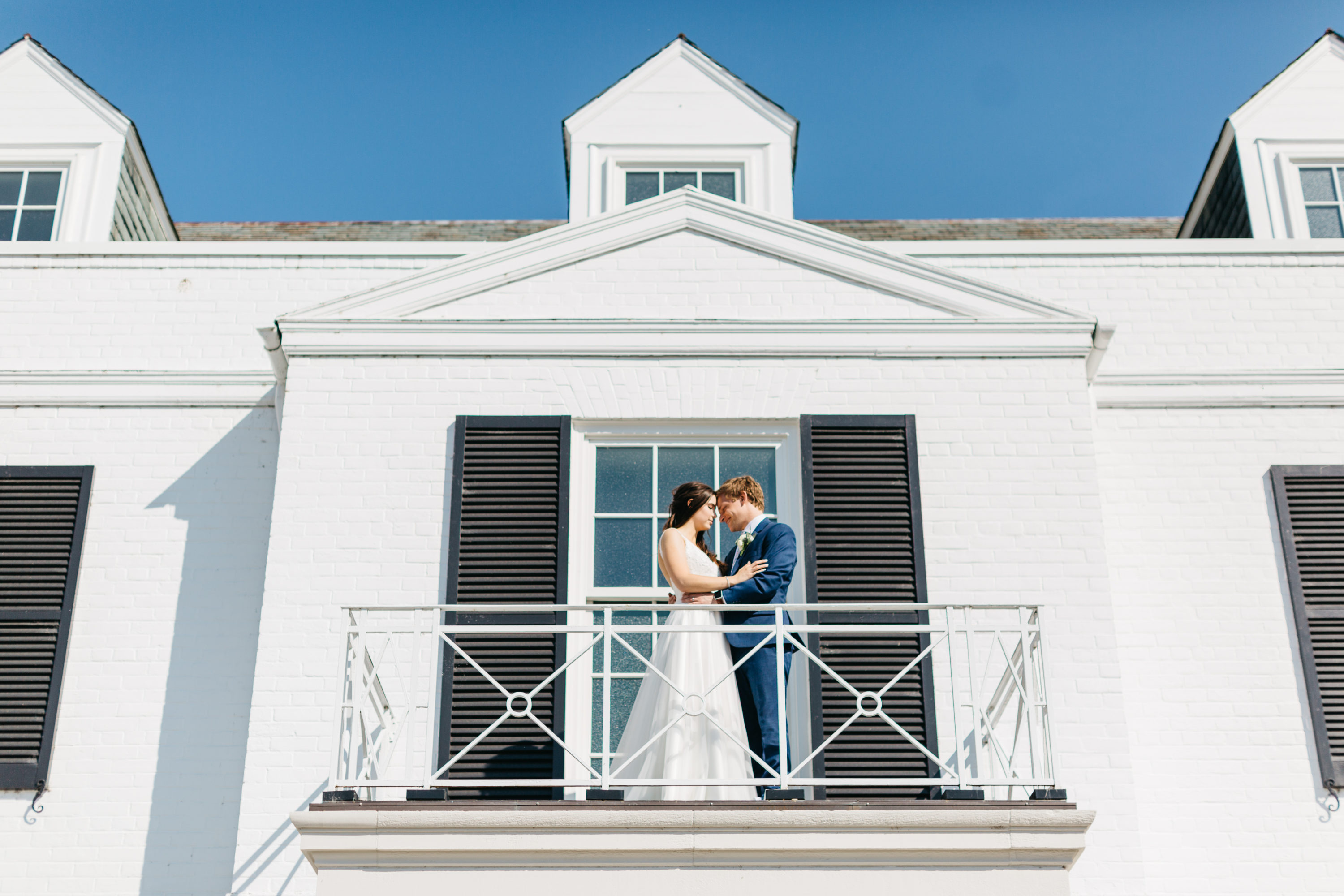 Bride and groom cuddling on Harding Waterfront Estate balcony