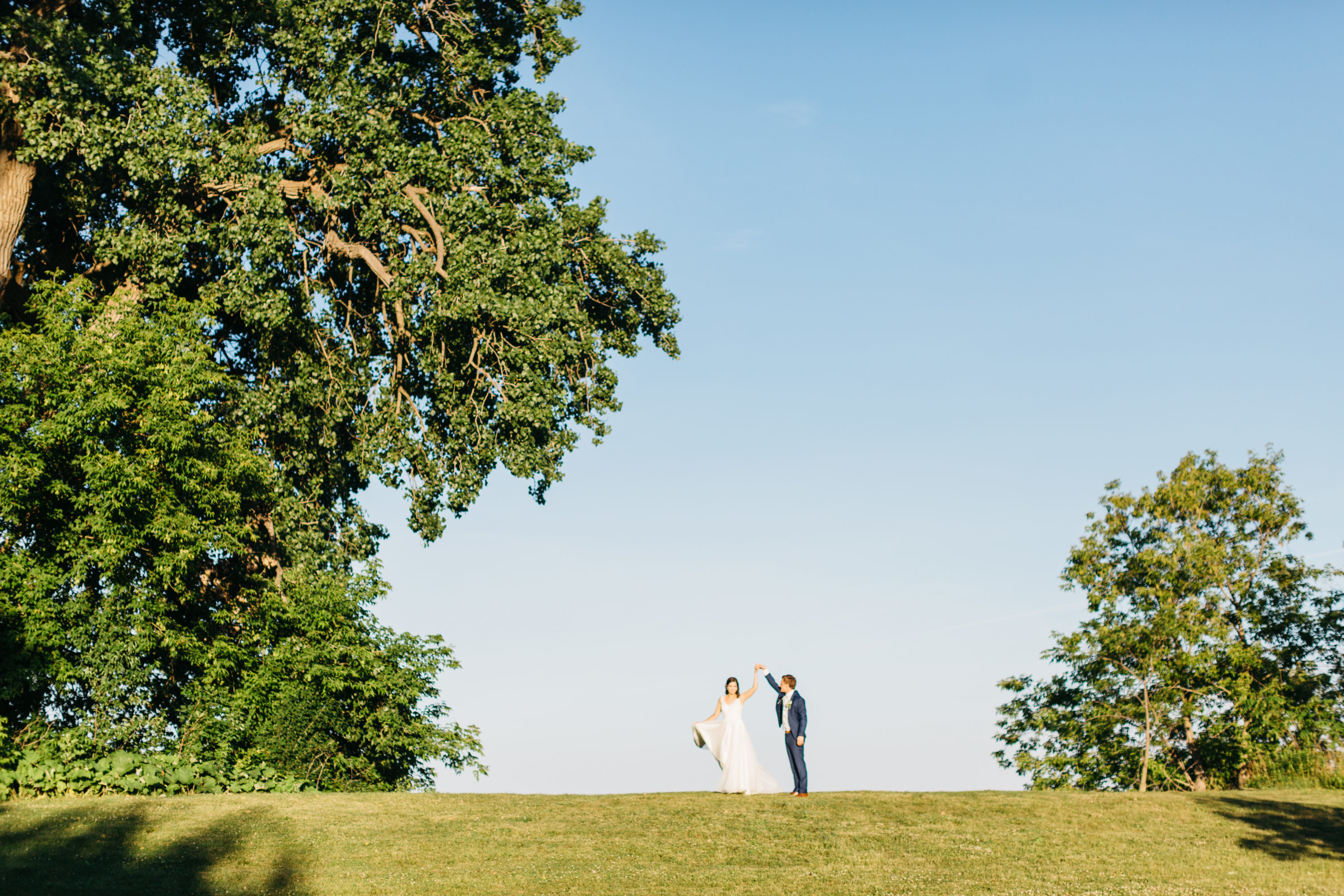Bride and groom dancing on top of hill at Harding Waterfront Estate
