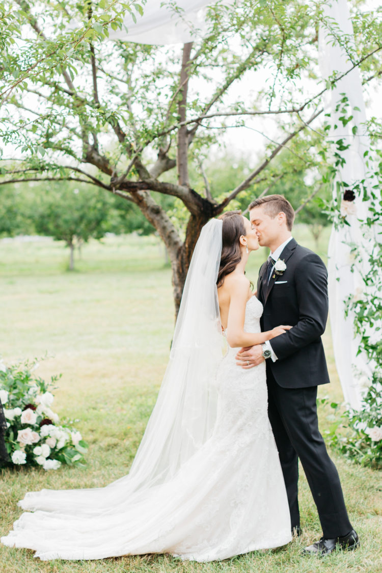 Bride and groom first kiss at Kurtz Orchard Market place