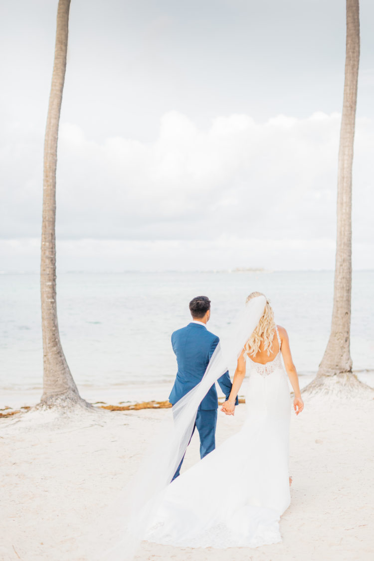 couple walking on beach during destination weddding