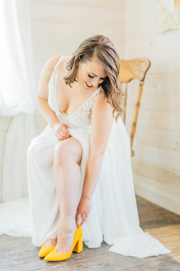 Bride putting on shoes at Stonewall Estates