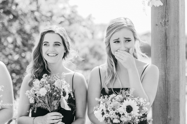 Bridesmaids crying during wedding ceremony
