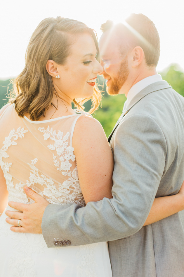 Bride and groom hugging during sunset at Stonewall Estates