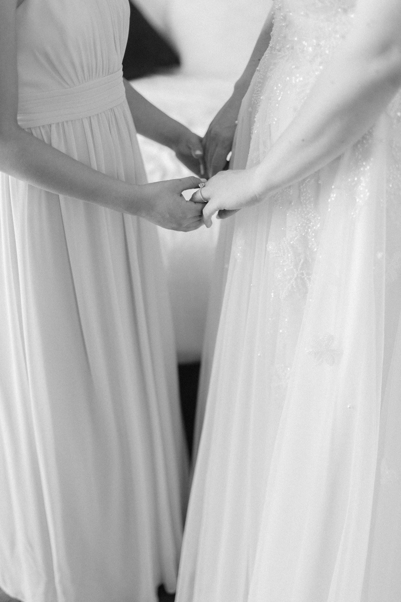 Bride holding hands with niece who is a junior bridesmaid