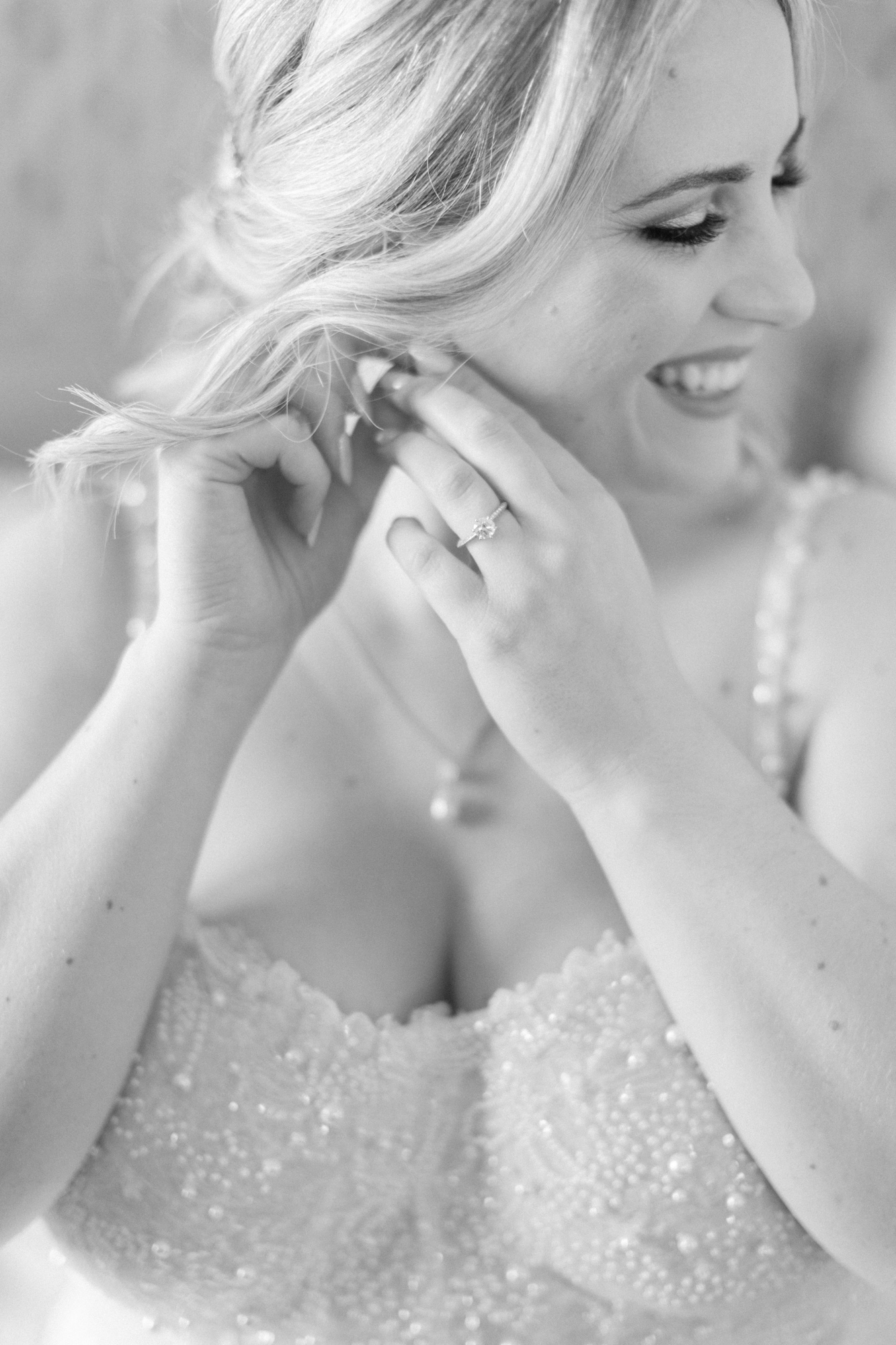 Bride putting on earrings captured by Toronto Wedding Photographer Paula Visco