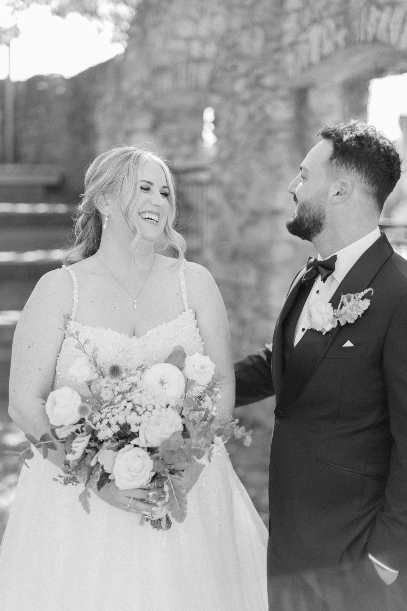 Black and white portrait of bride and groom, laughing by Toronto wedding photographer Paula Visco photography