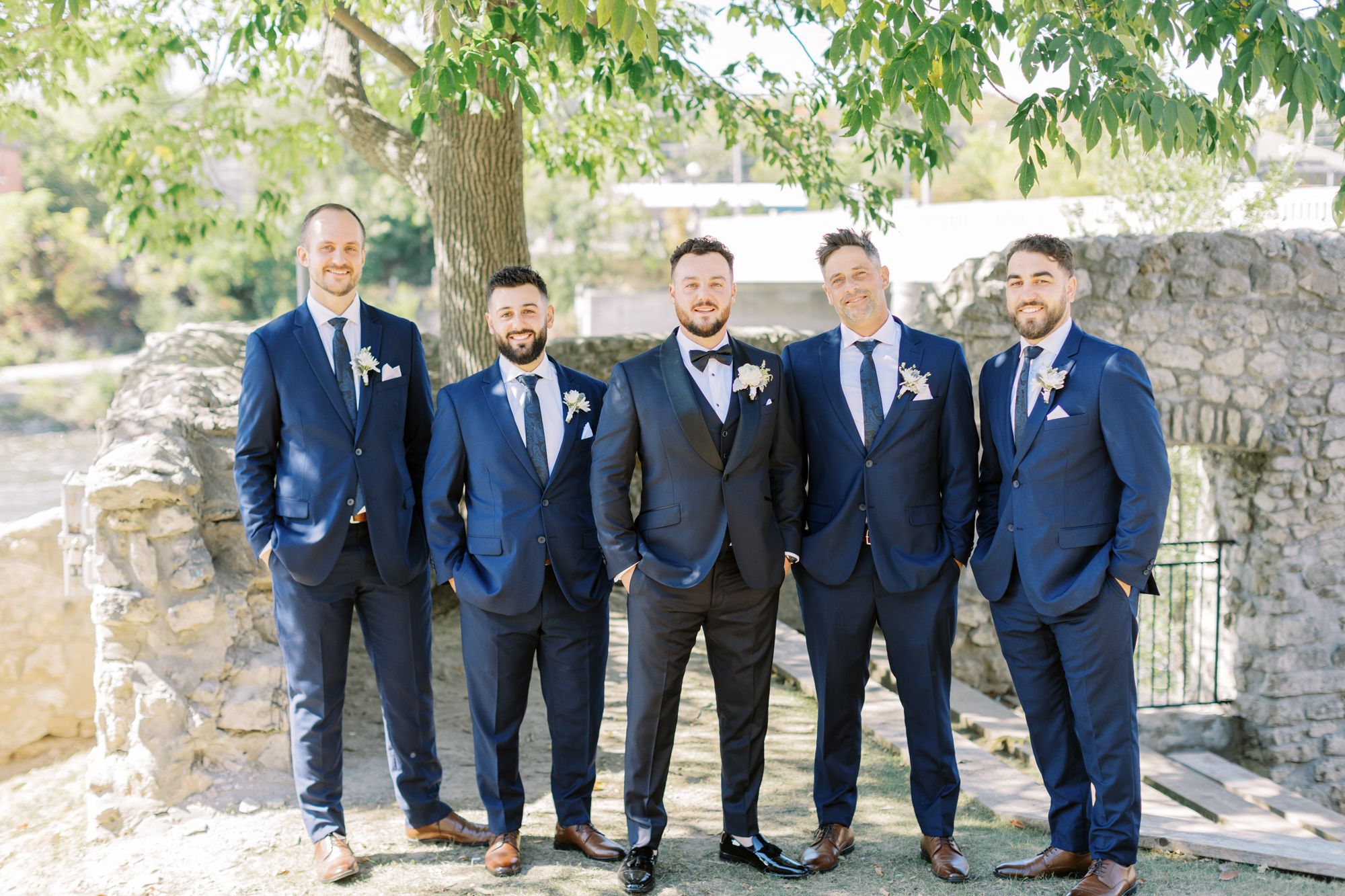 Groom with groomsmen, smiling at Cambridge Mel wedding