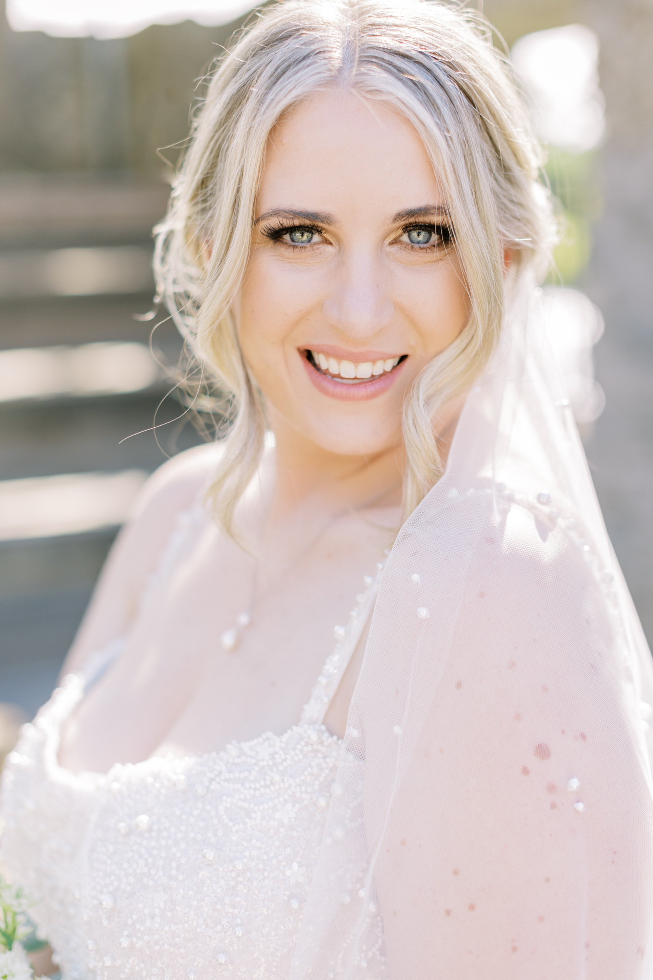 Portrait of bride, smiling with a pearl veil, taken by Toronto Wedding Photographer Paula Visco photography