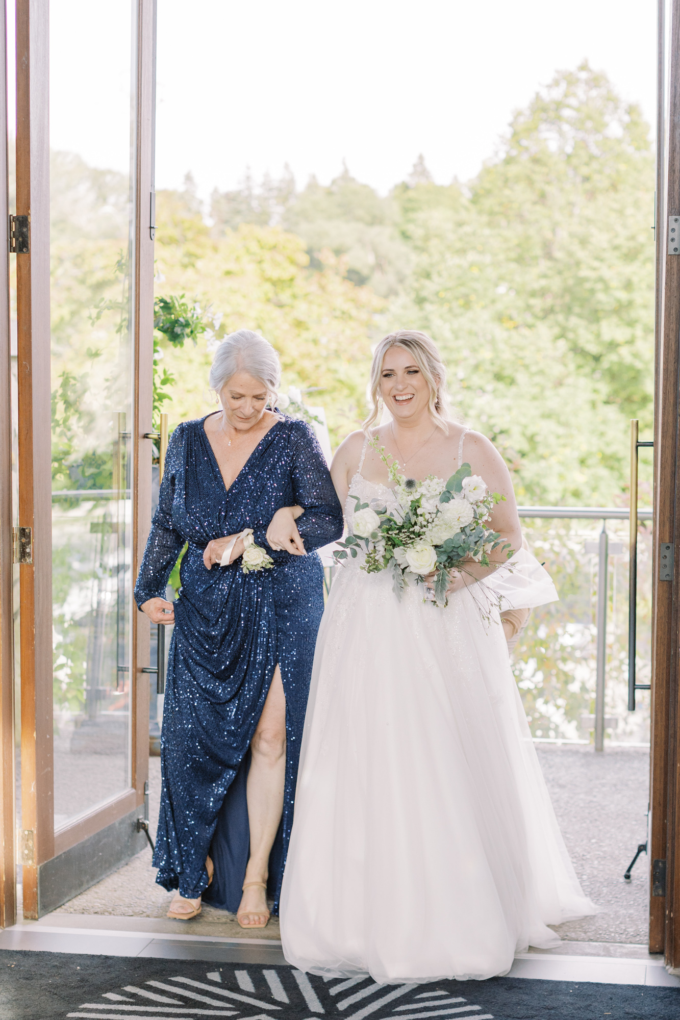 Bride walking in with mom at Cambridge Mill wedding