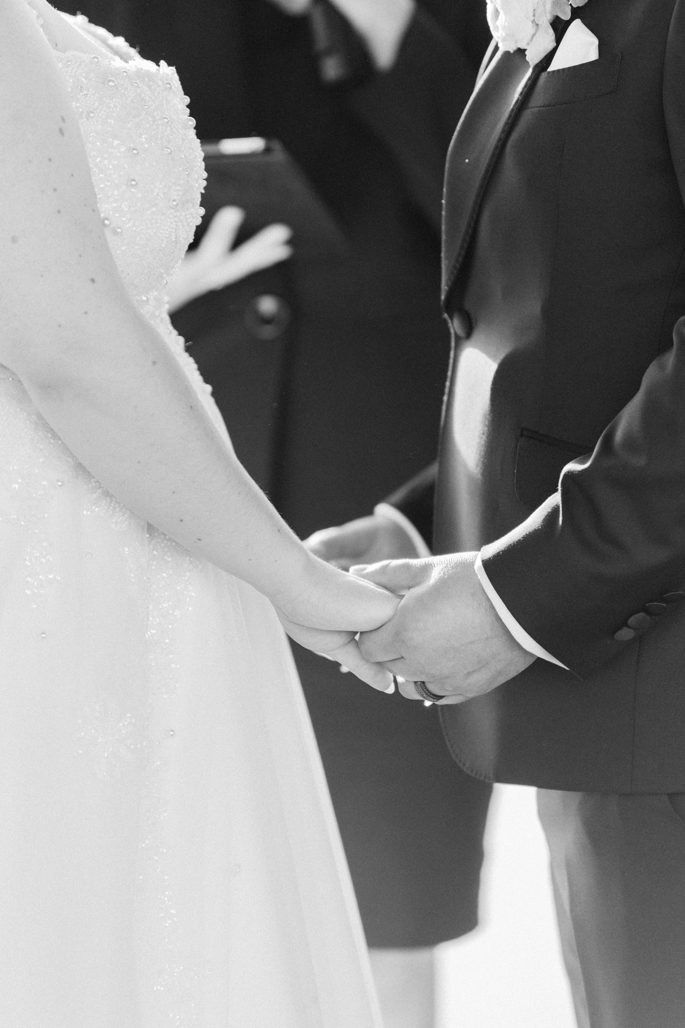 Close up of bride and groom, holding hands during ceremony
