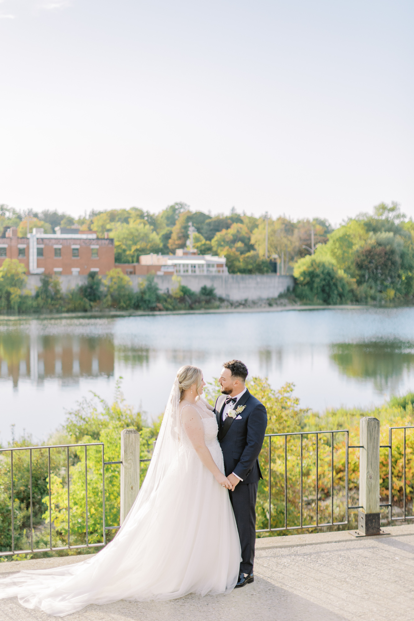 Bride and groom holding hands during fall wedding at Cambridge Mill 