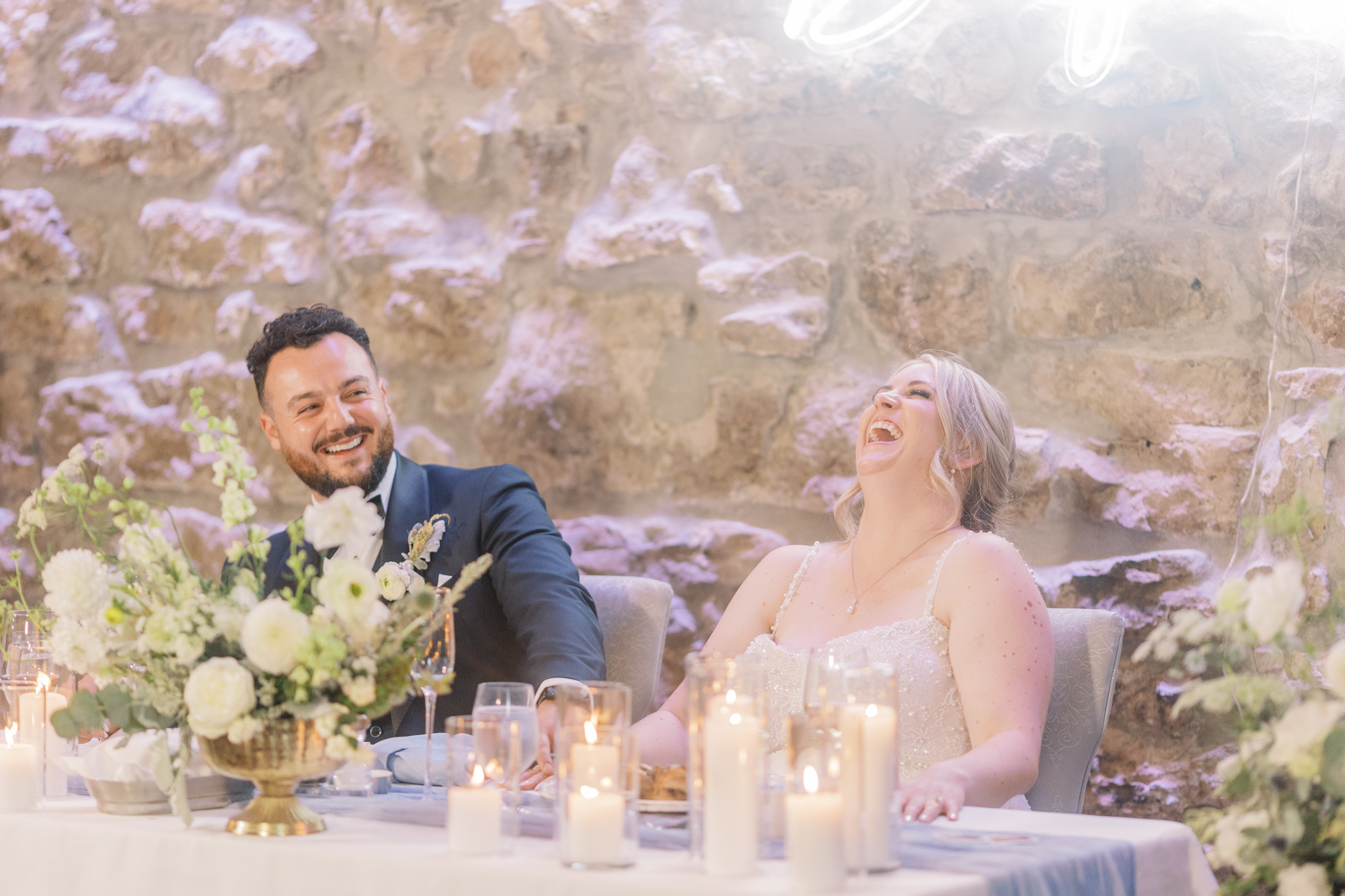 Bride and groom, laughing during wedding reception in Gallery room at Cambridge Mill wedding