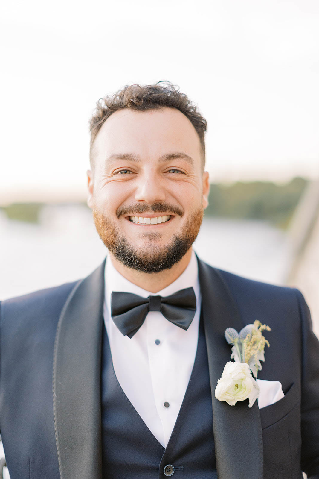 Groom, smiling during sunset photos at Cambridge Mill wedding