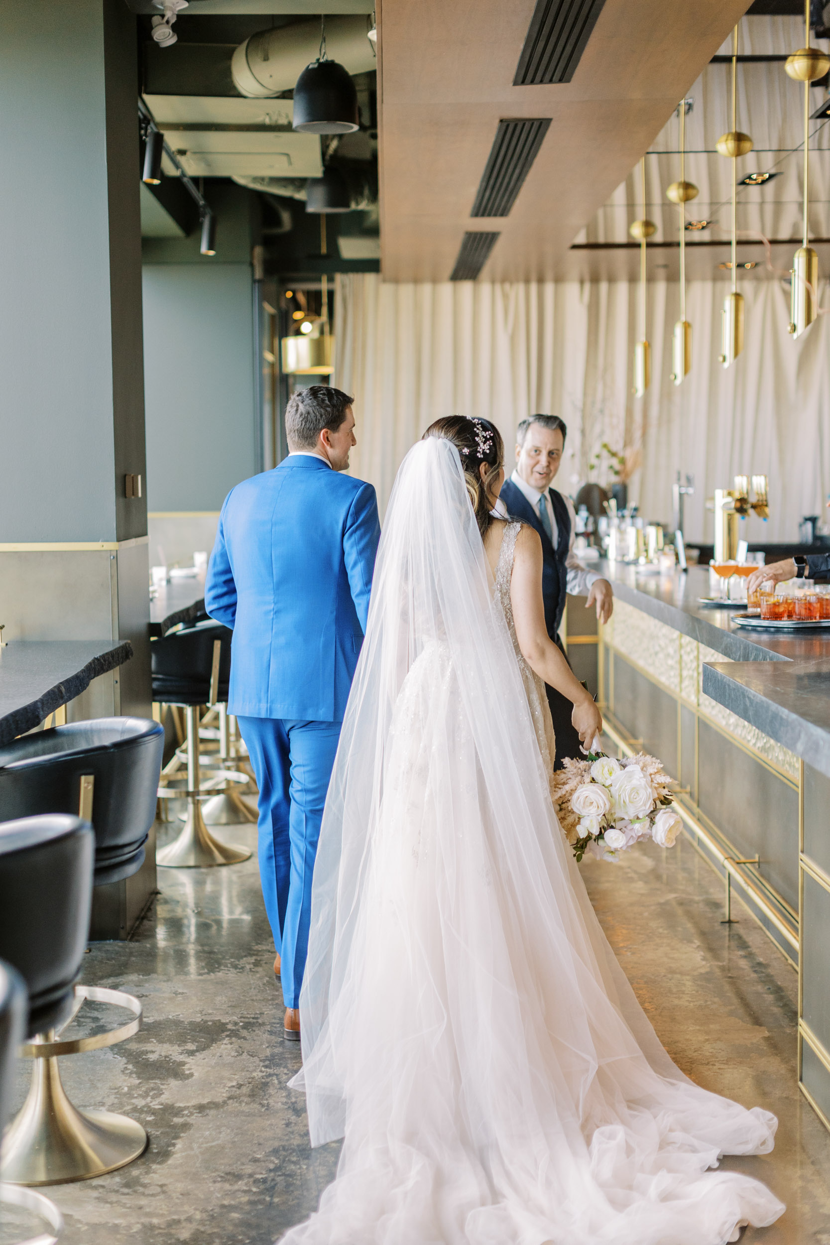 Bride and groom walking through bar at Canoe Restaurant