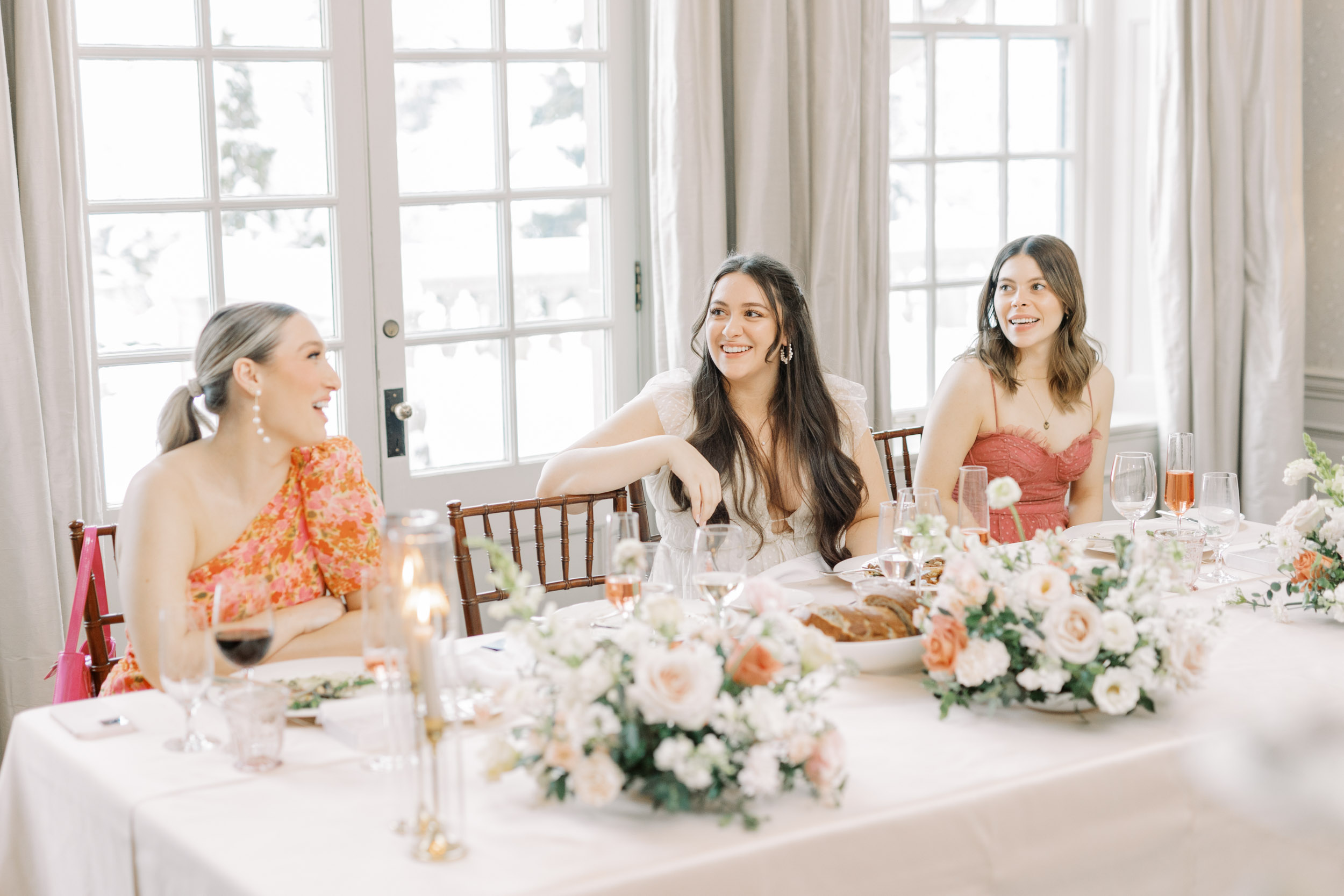 Bride laughing with bridesmaids at bridal shower
