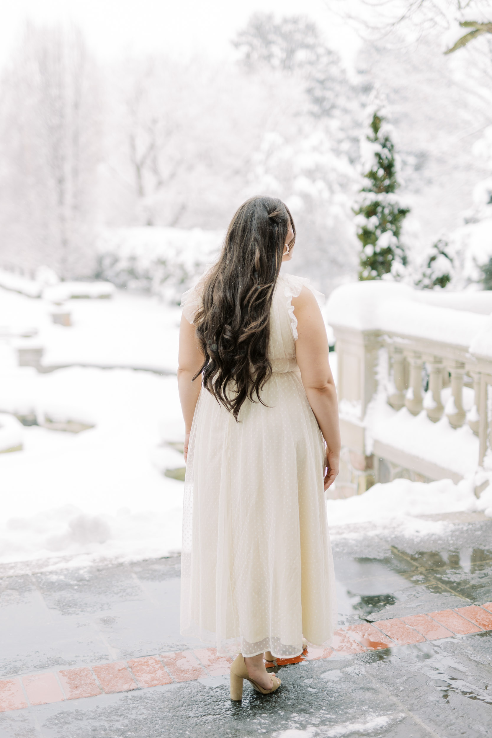 Bride looking at snowy backyard at Graydon Hall