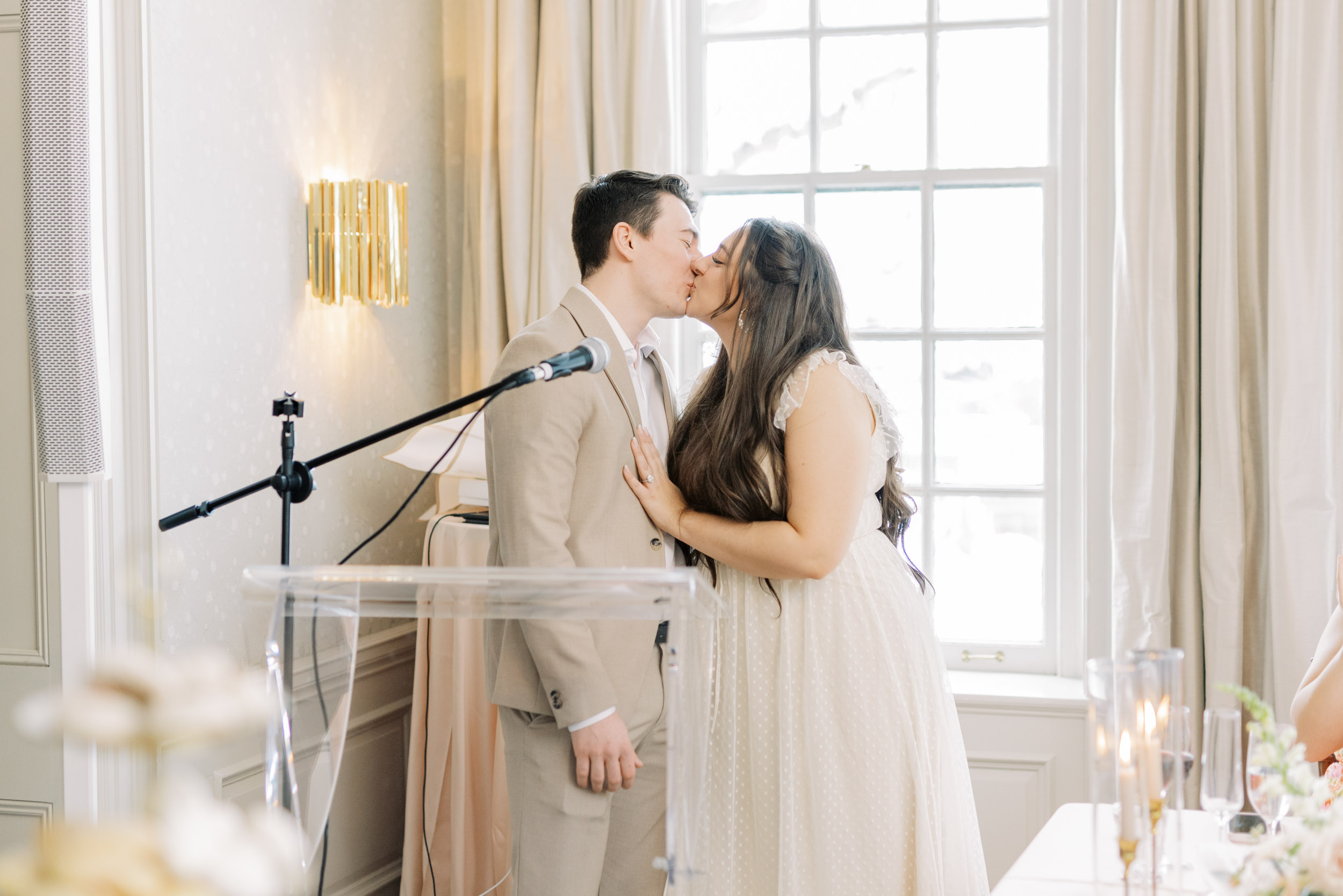 Bride and groom kissing after speech at Bridal Shower