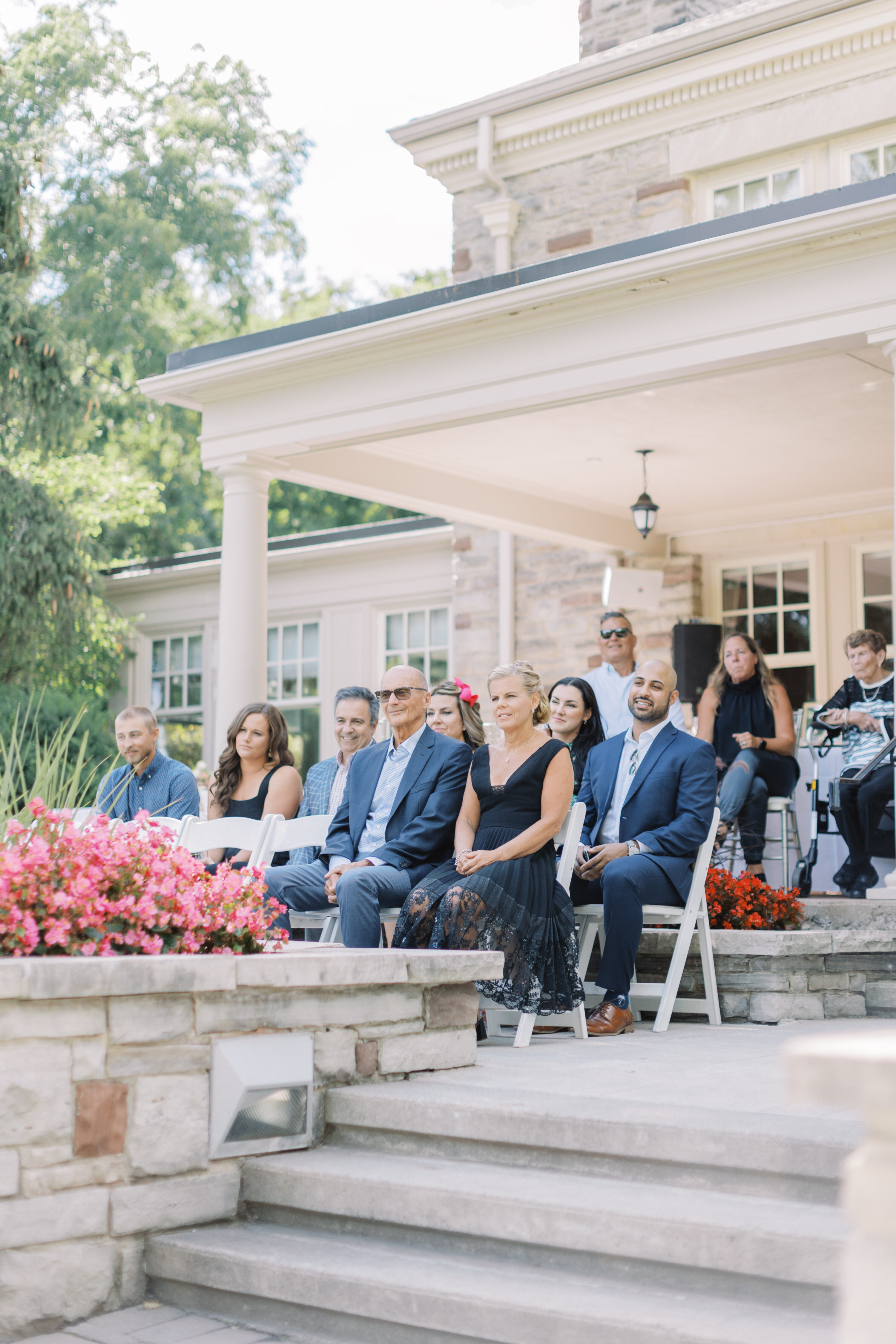 Guest sitting on balcony during wedding ceremony at Paletta Mansion