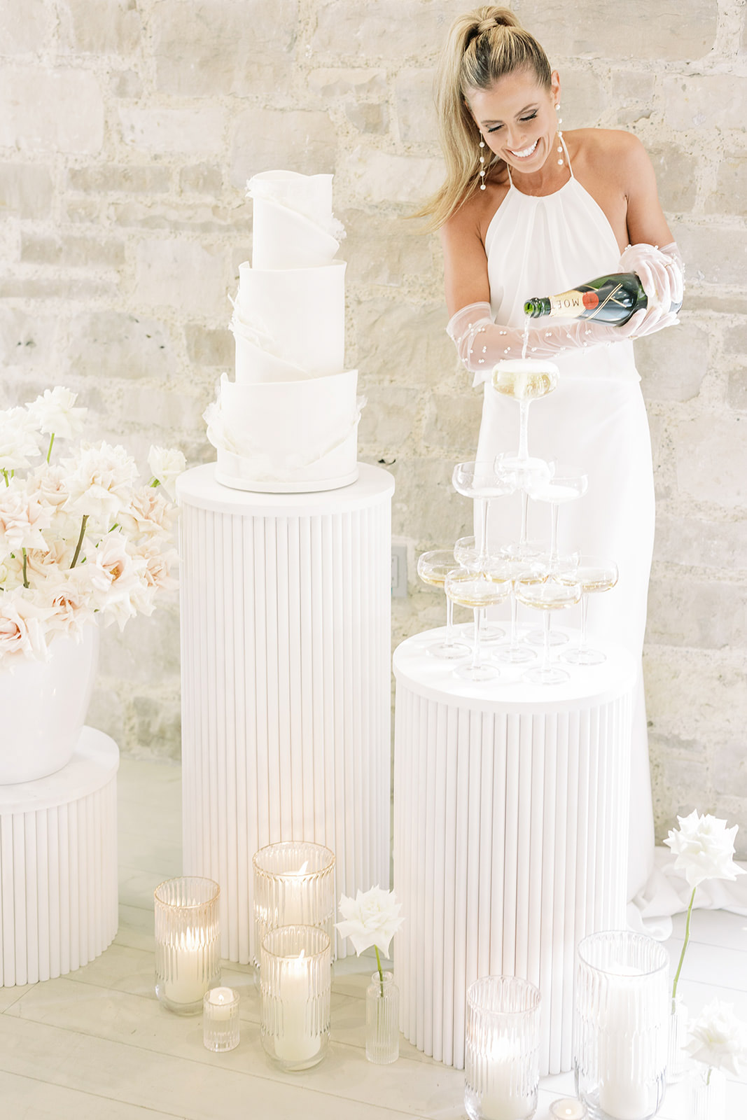 Bride pouring Moet bottle into Champagne tower for Elora Mill Wedding Editorial featured Wedding Chicks