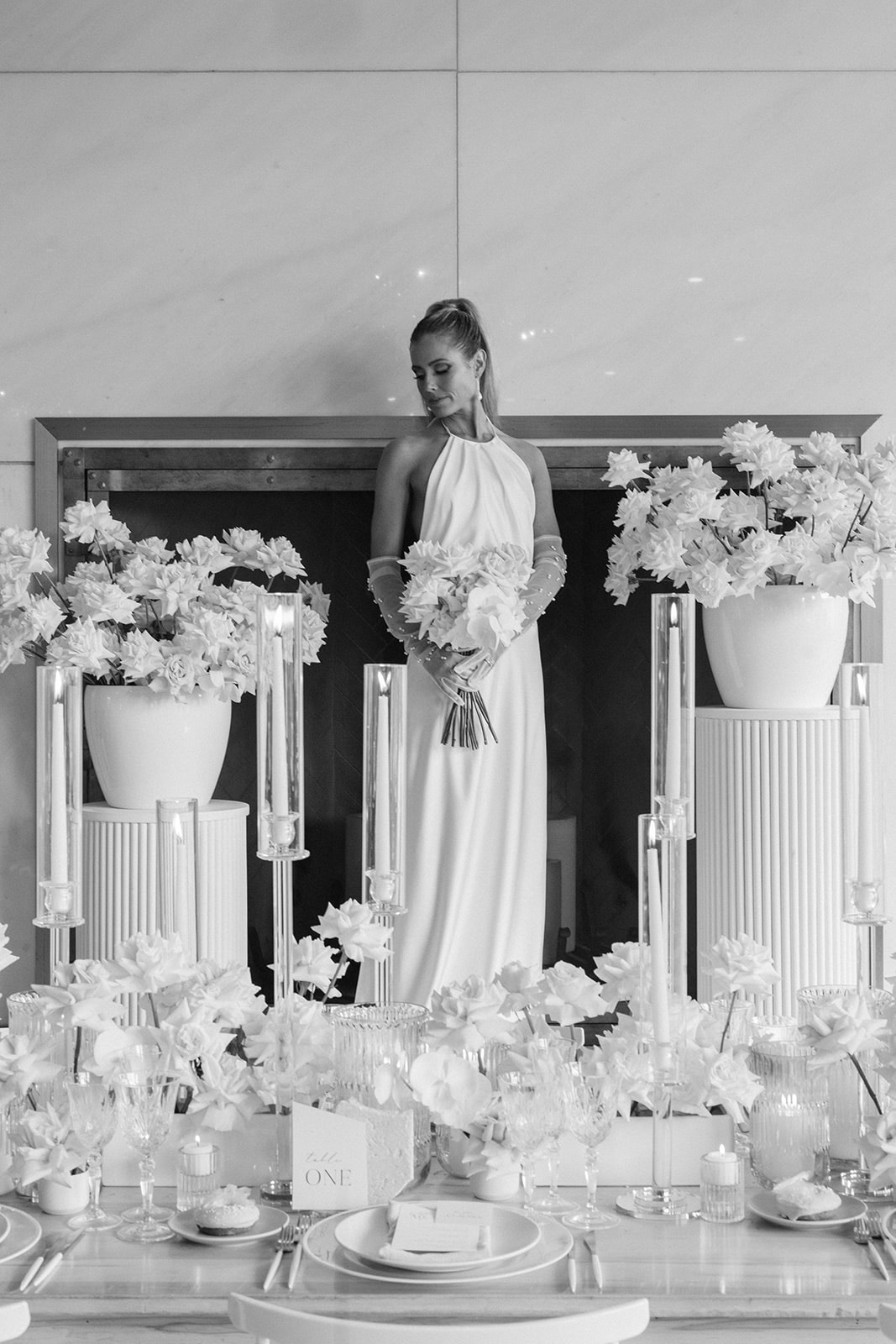 Black and white photo of bride standing in front of head table at Elora Mill Wedding Editorial