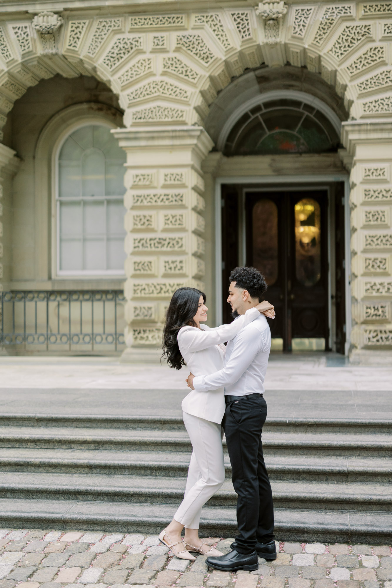 Couple holding each othr in front of Osgoode Hall Engagement Session