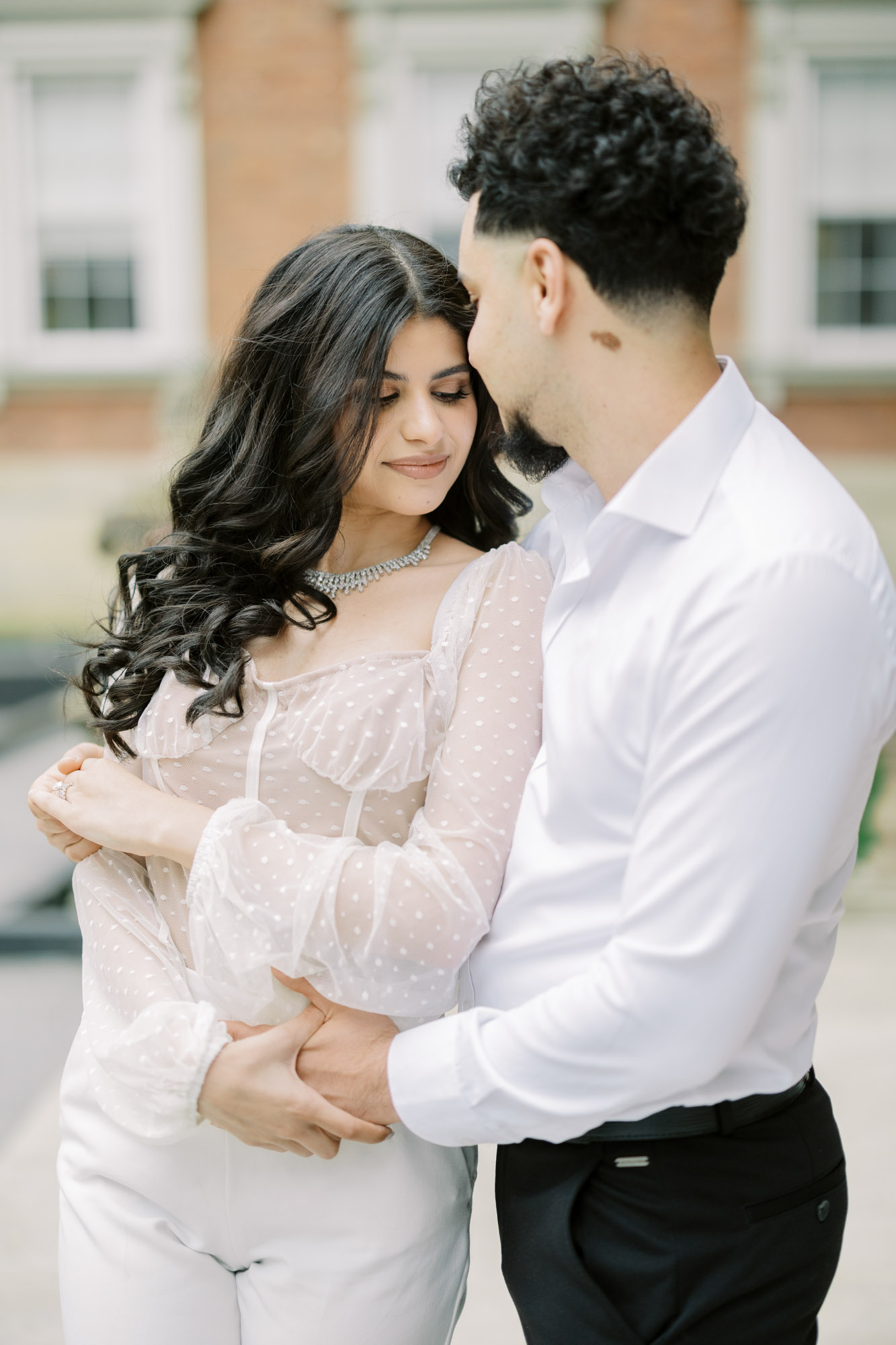 Couple cuddling at Osgoode Hall engagement session