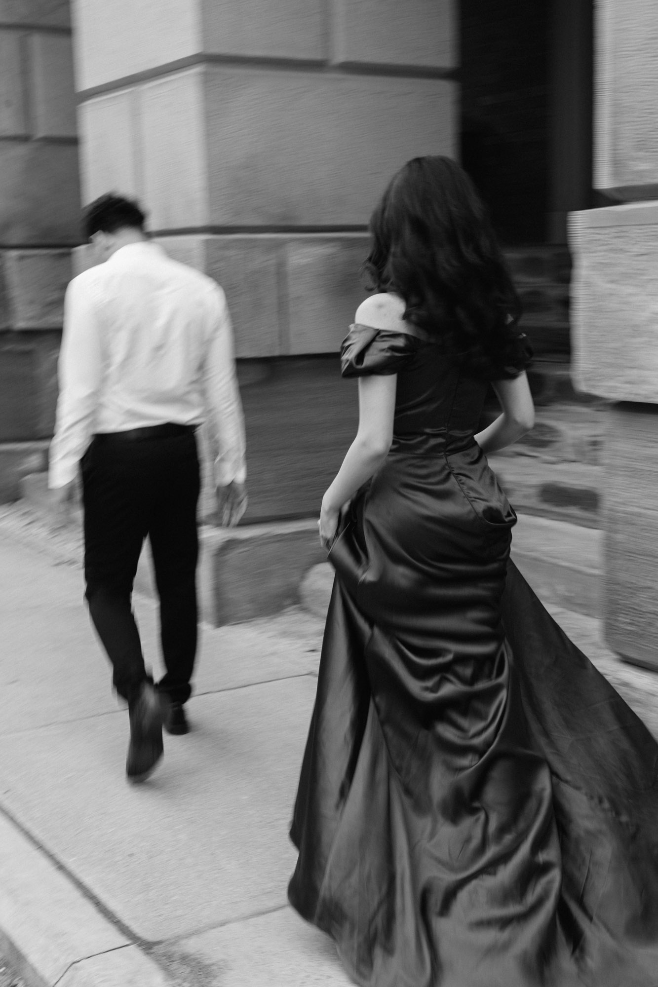Black and white editorial styled photo of couple walking at Osgoode Hall Engagement Session