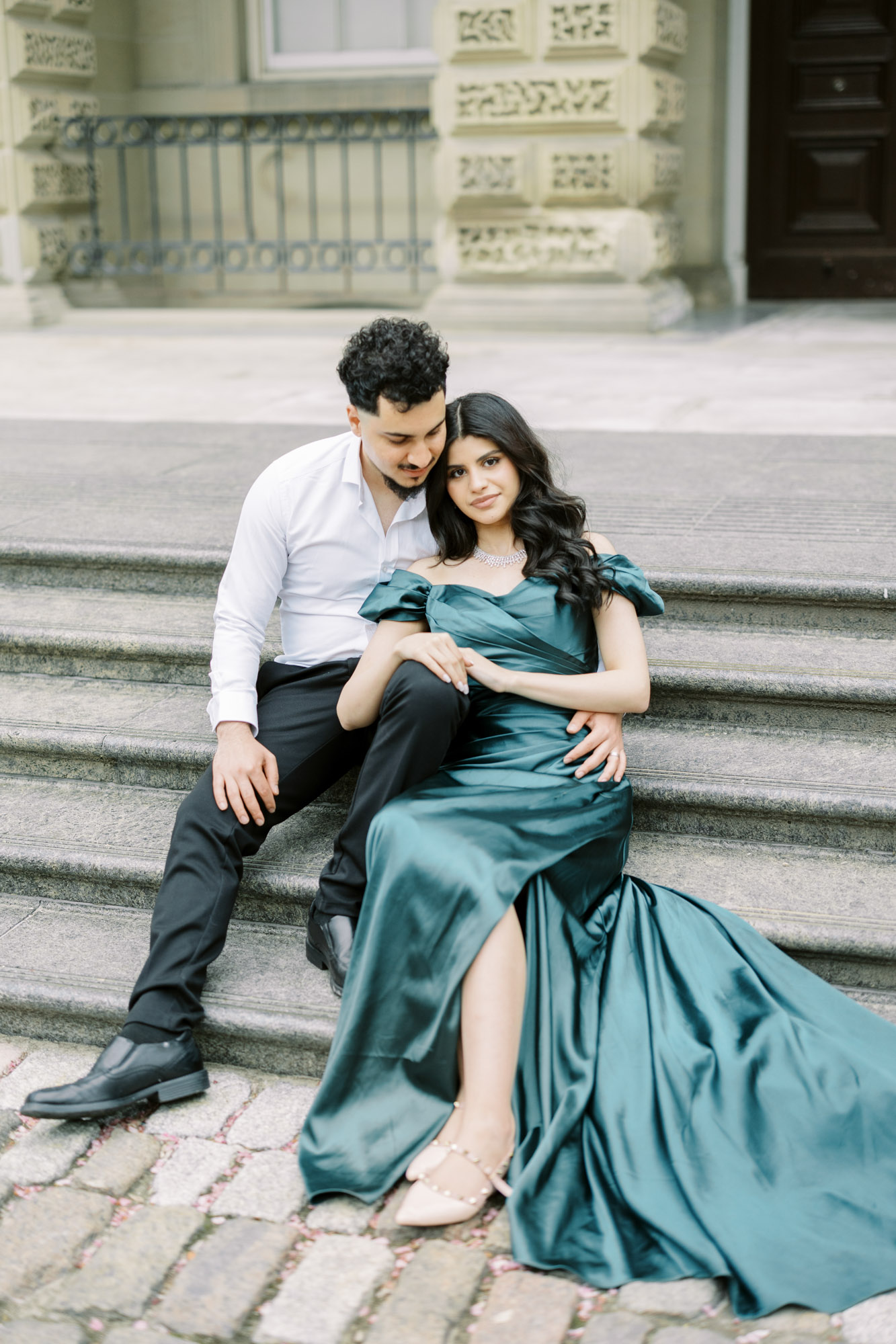 Couple sitting stairs at Osgoode Hall engagement session