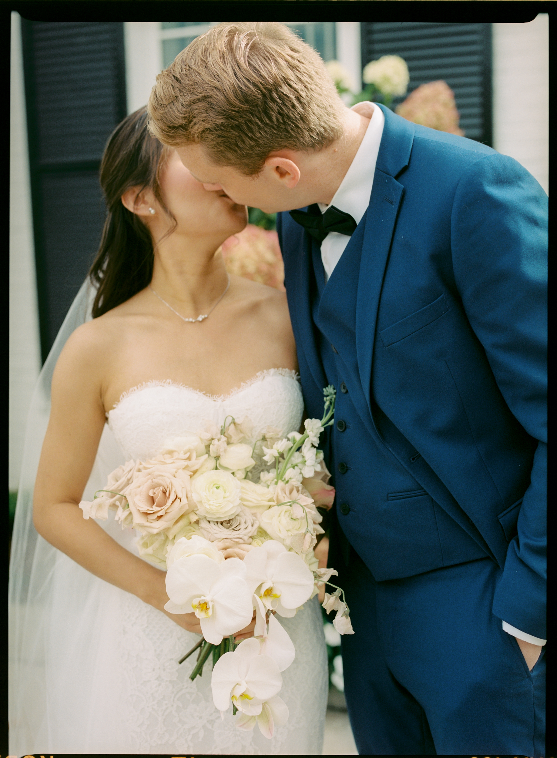 Film photograph of bride and groom kissing at Harding Waterfront Estate 