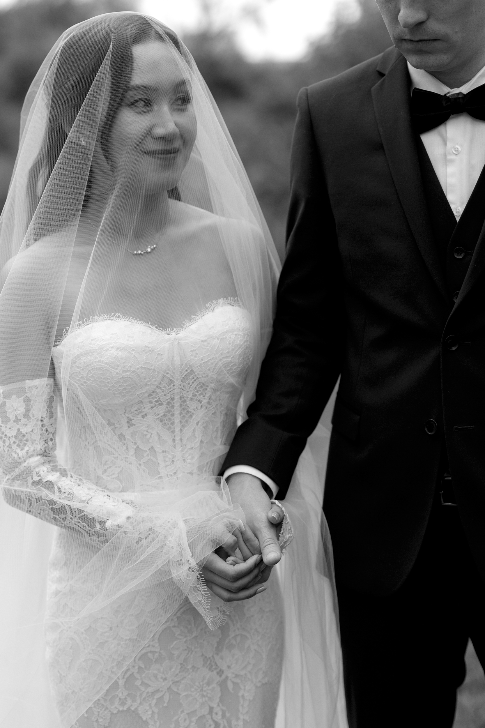 Bride holding grooms hand during ceremony