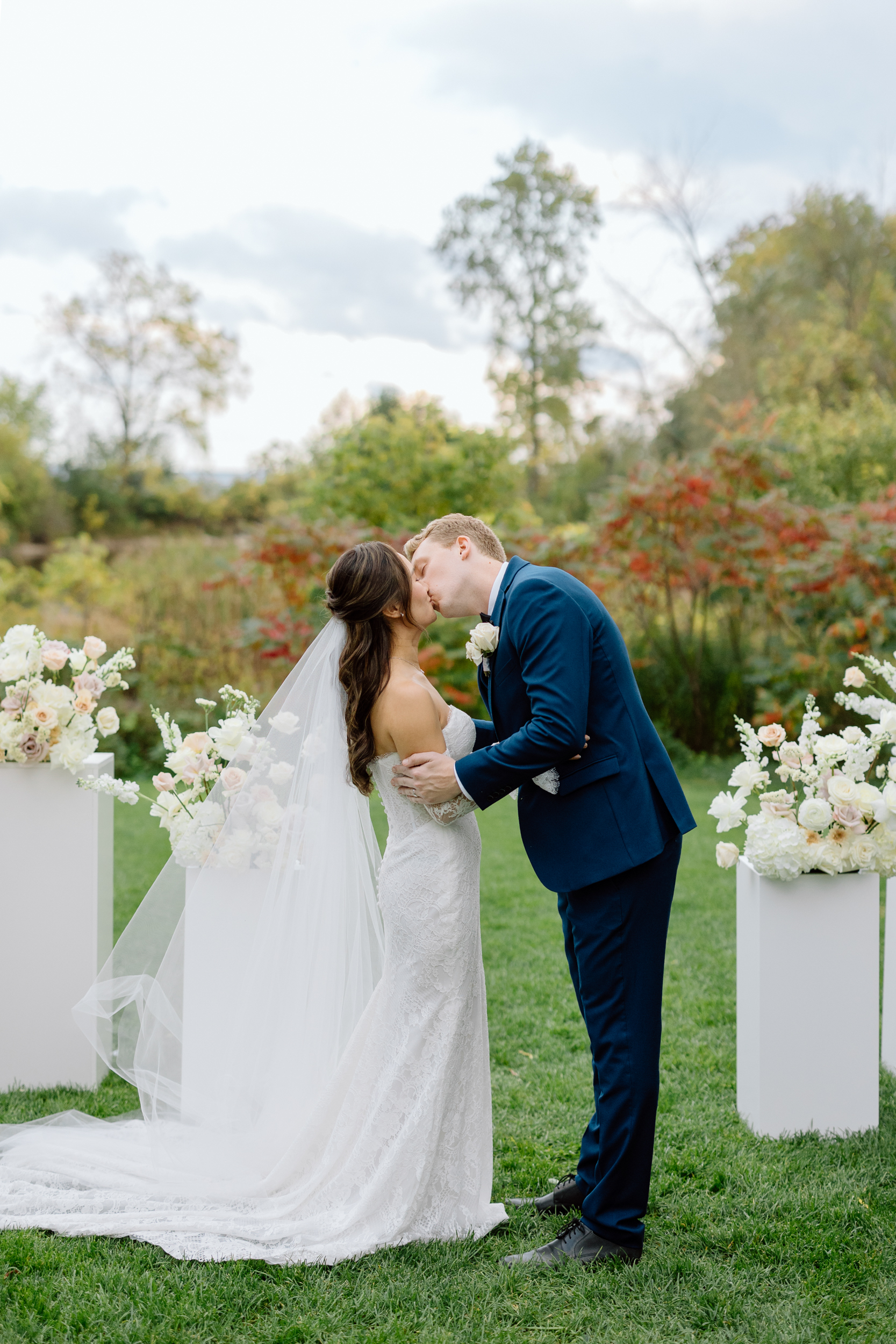 Bride and groom's first kiss during ceremony at Harding Waterfront Estate 