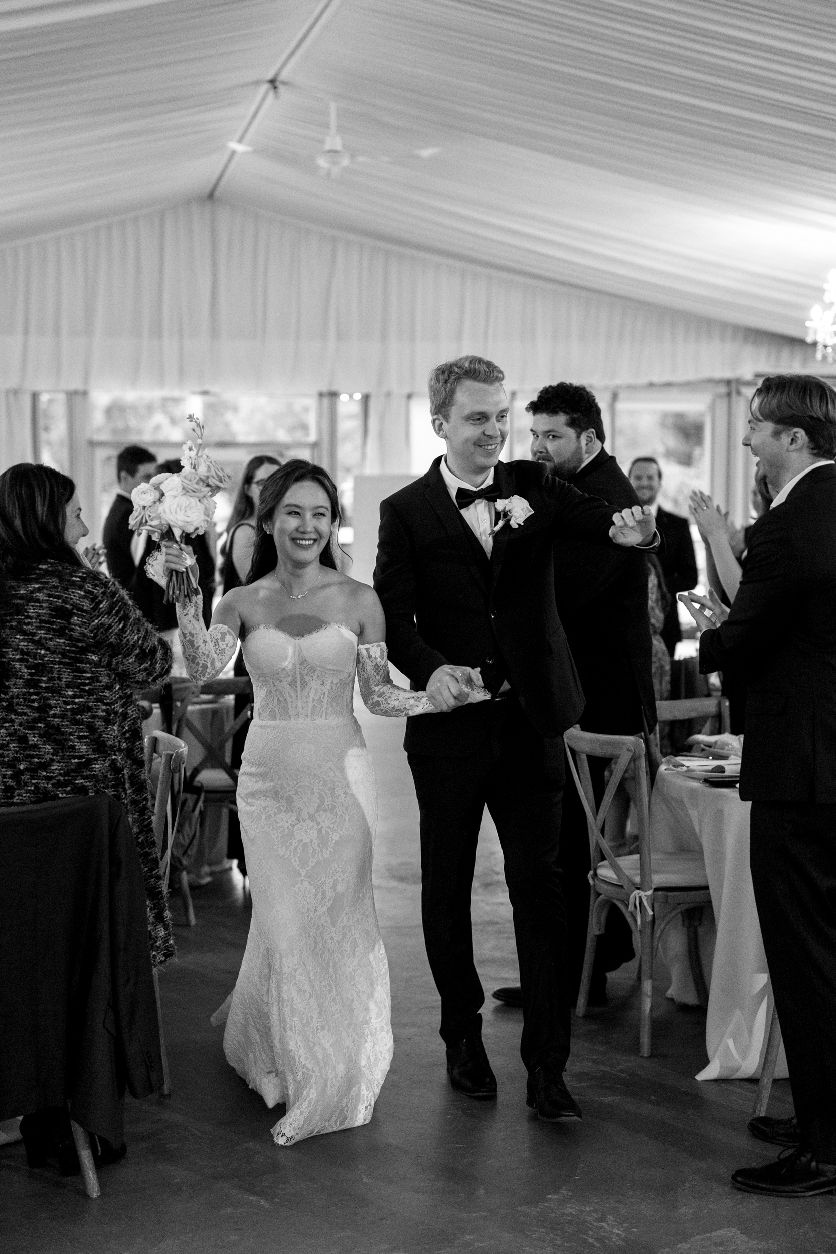 Bride and groom walking into reception at Harding Waterfront Estate wedding