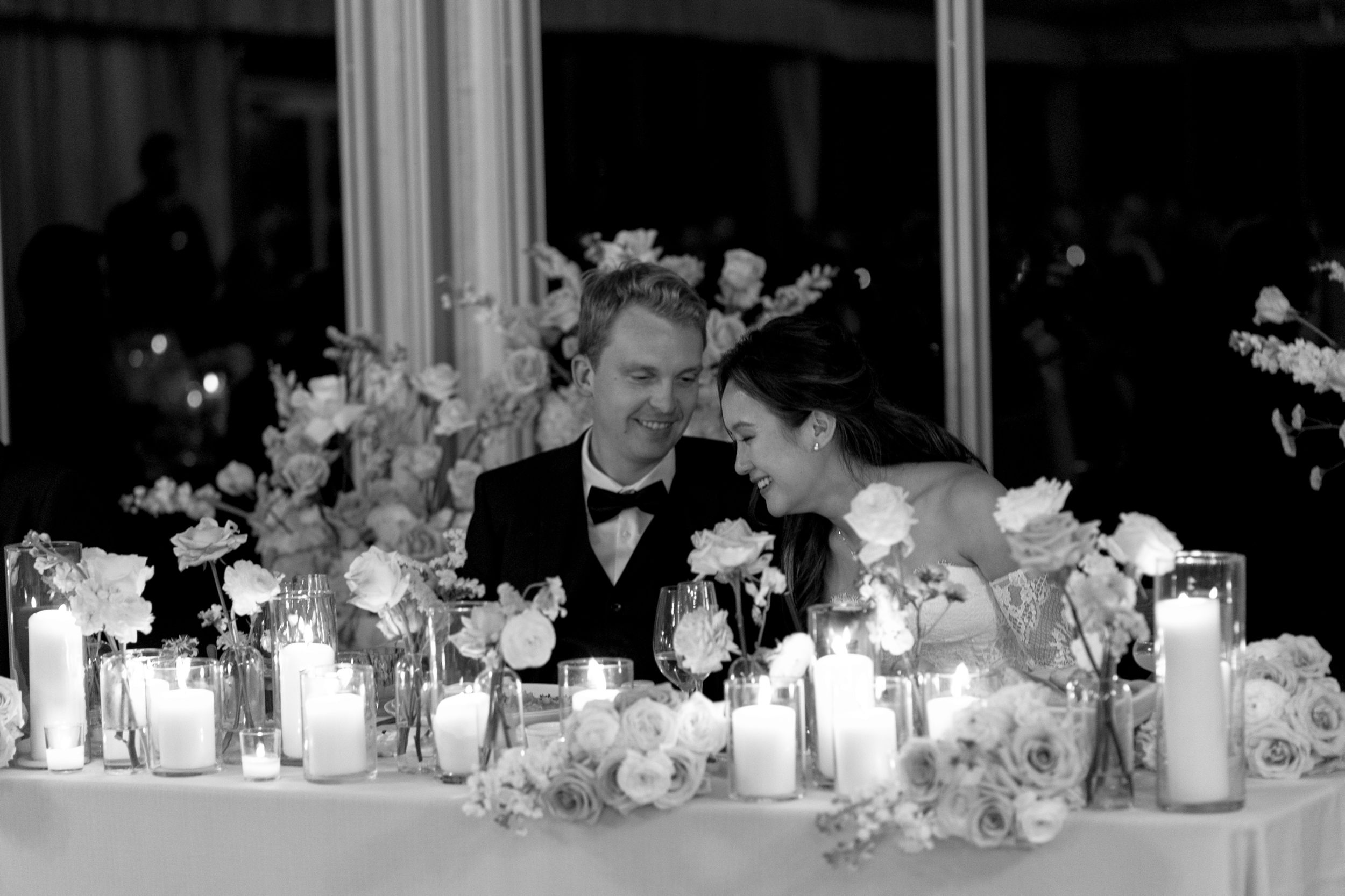 Bride and groom laughing during speeches